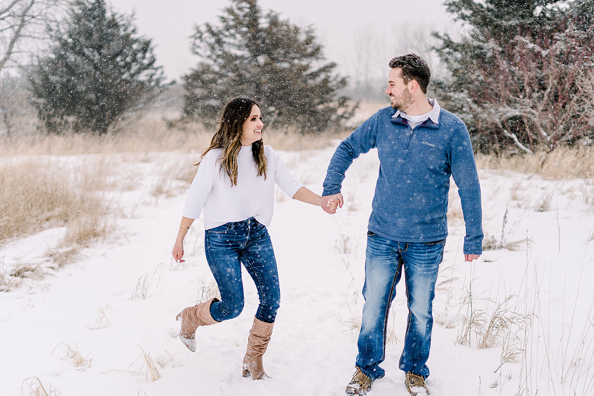 Couple running winter engagement session
