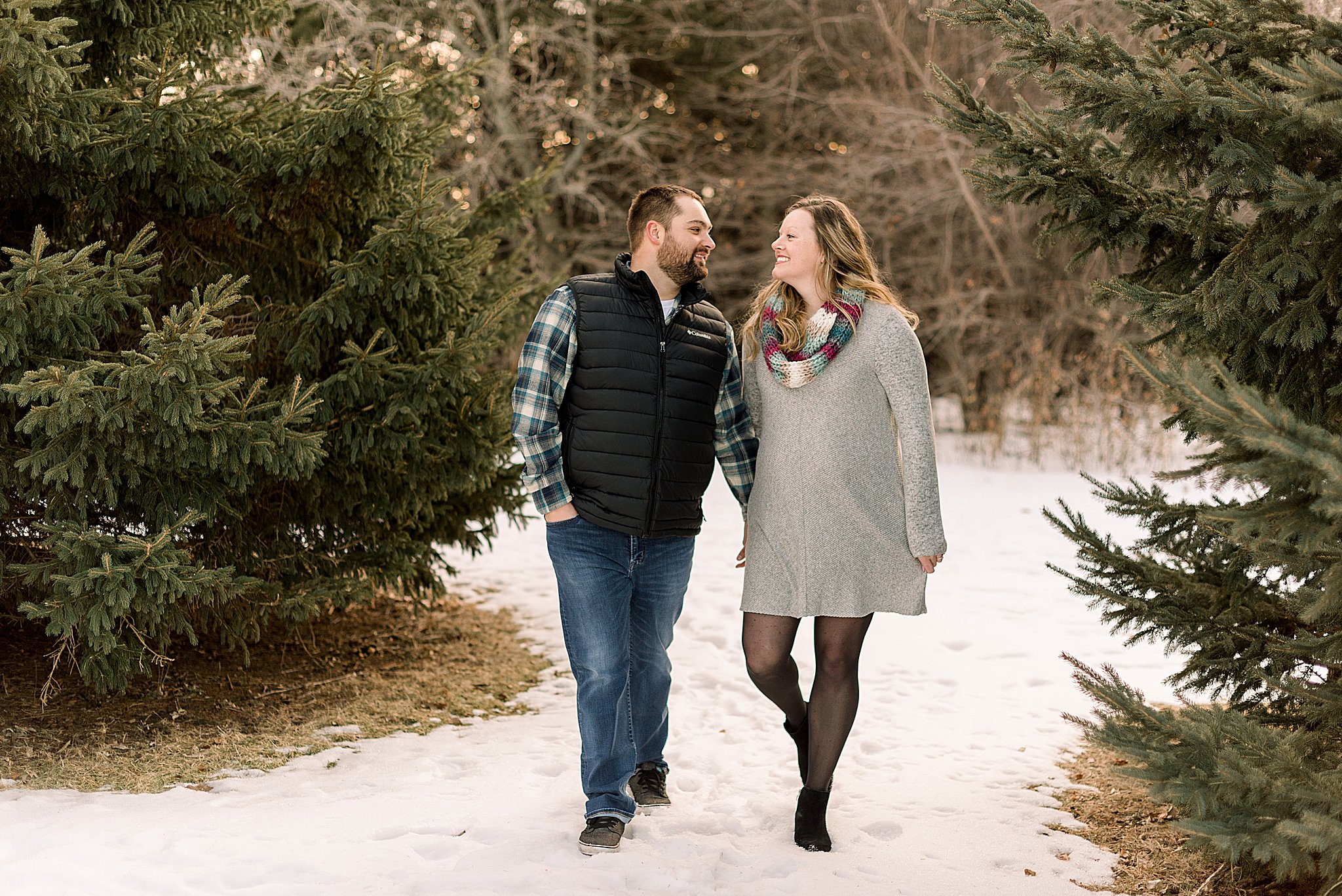 couple walking during engagement session sioux falls south dakota engagement session in sertoma park