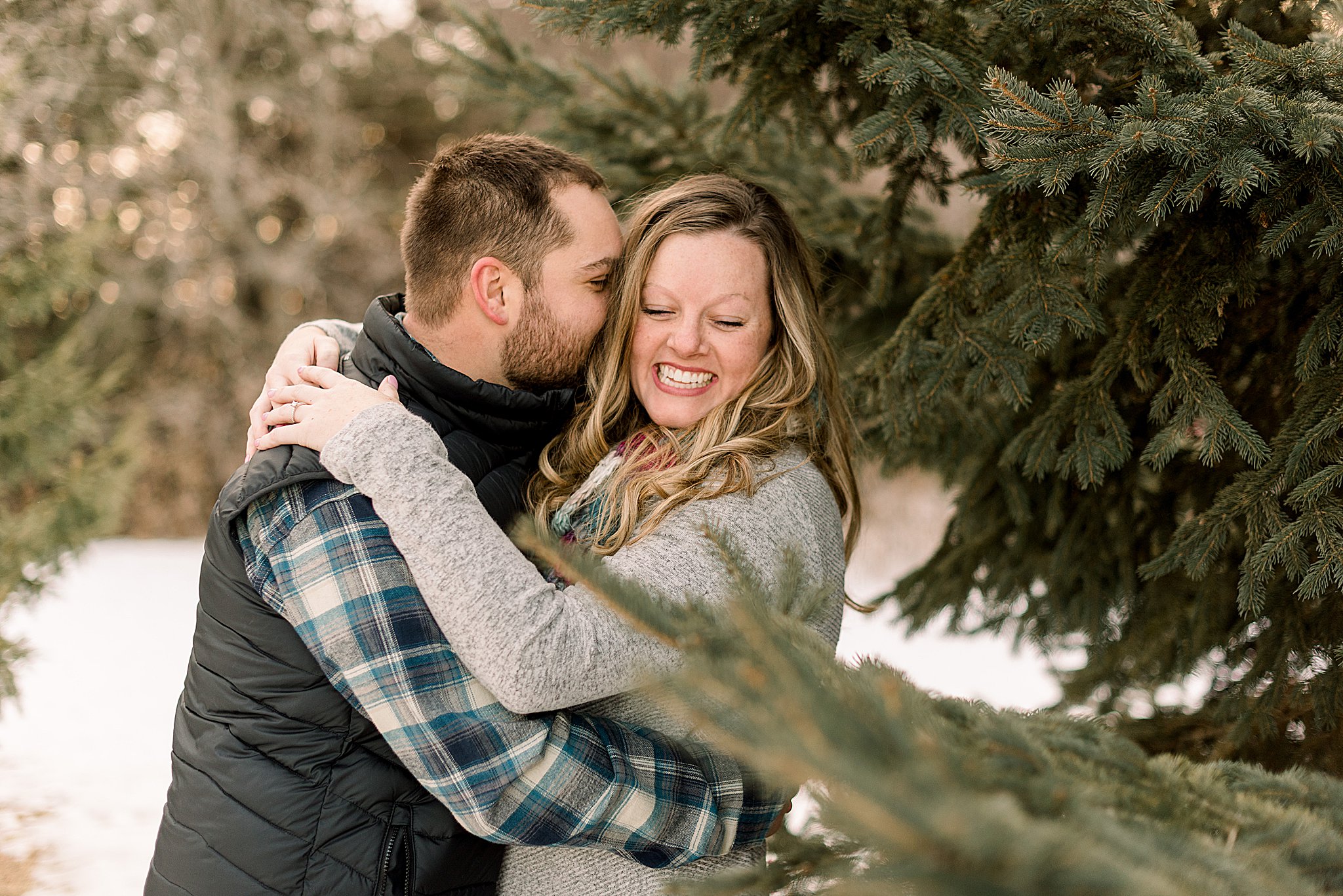 couple laughing during engagement session sioux falls south dakota engagement session in sertoma park