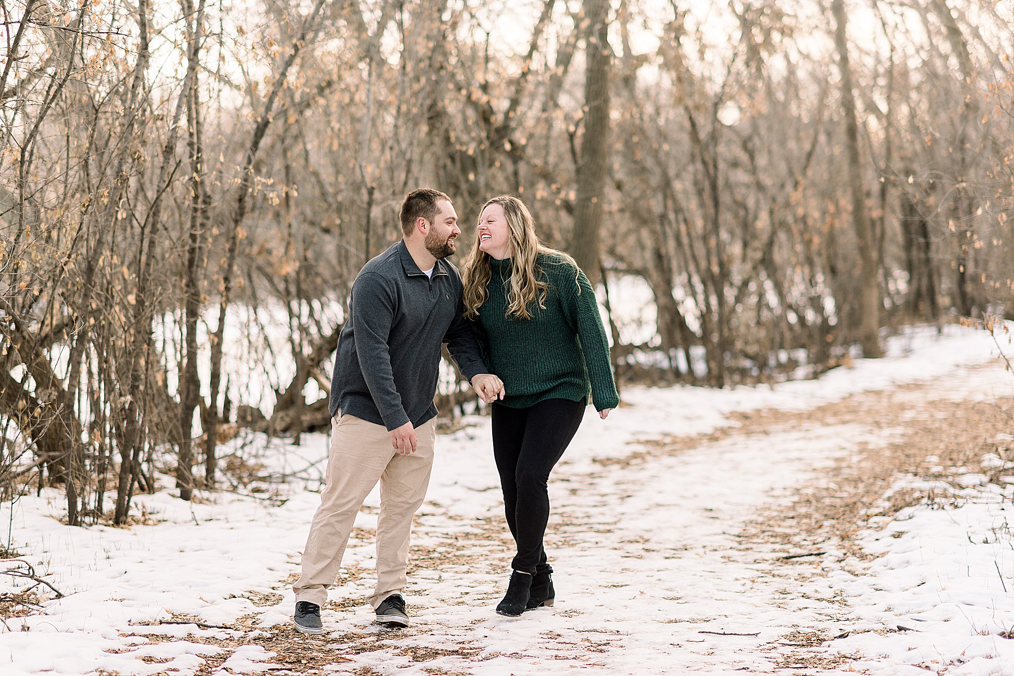 couple laughing during engagement session sioux falls south dakota engagement session in sertoma park