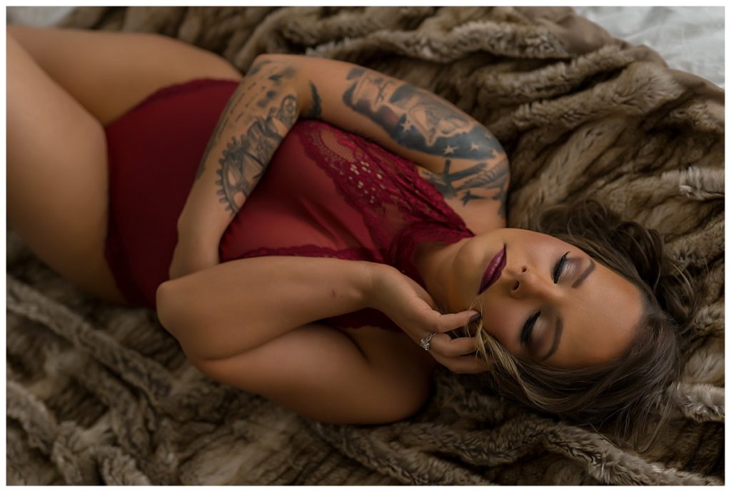 Woman laying on fluffy blanket for Emma Christine Photography