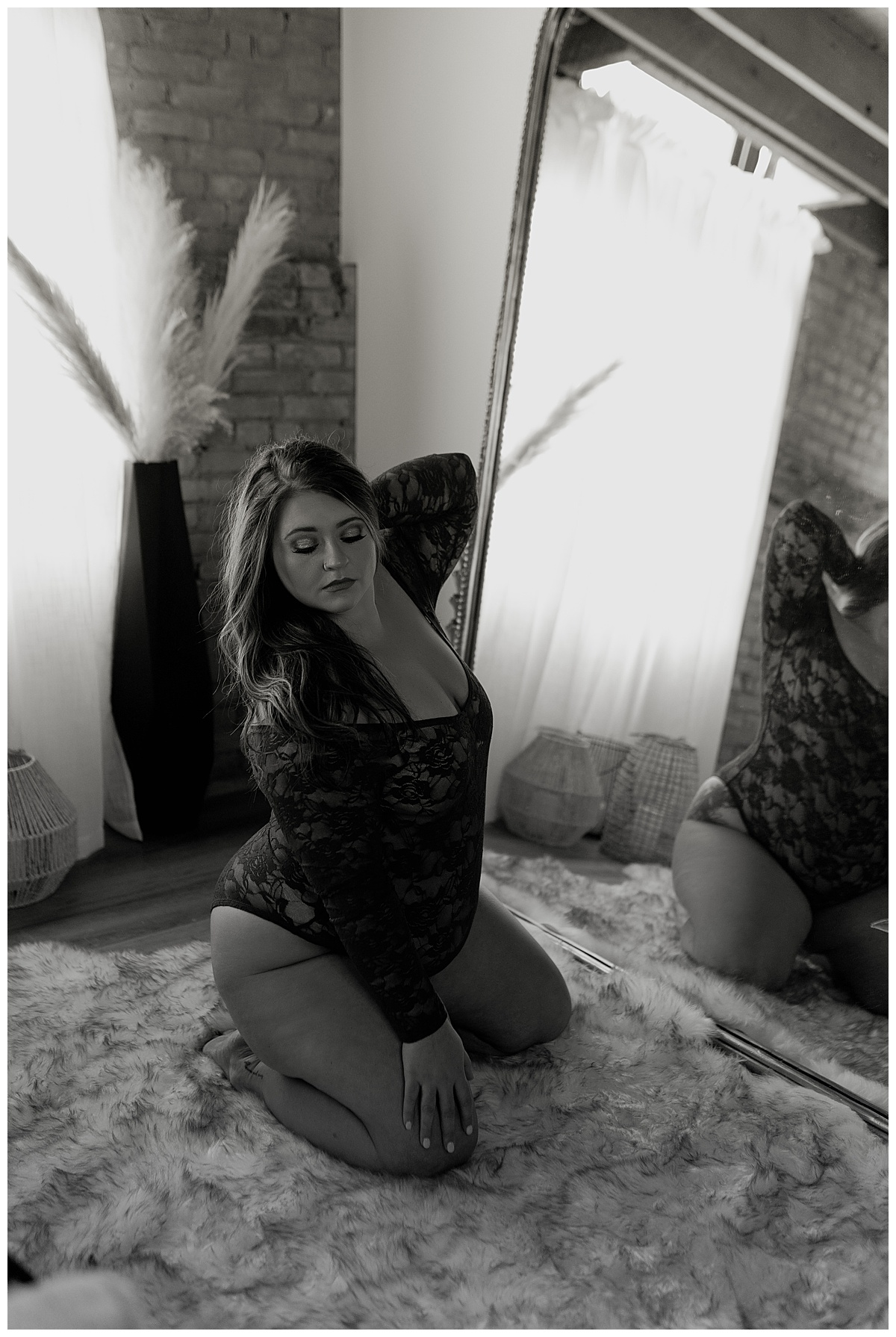 Future bride kneels in front of mirror for South Dakota Boudoir Photographer