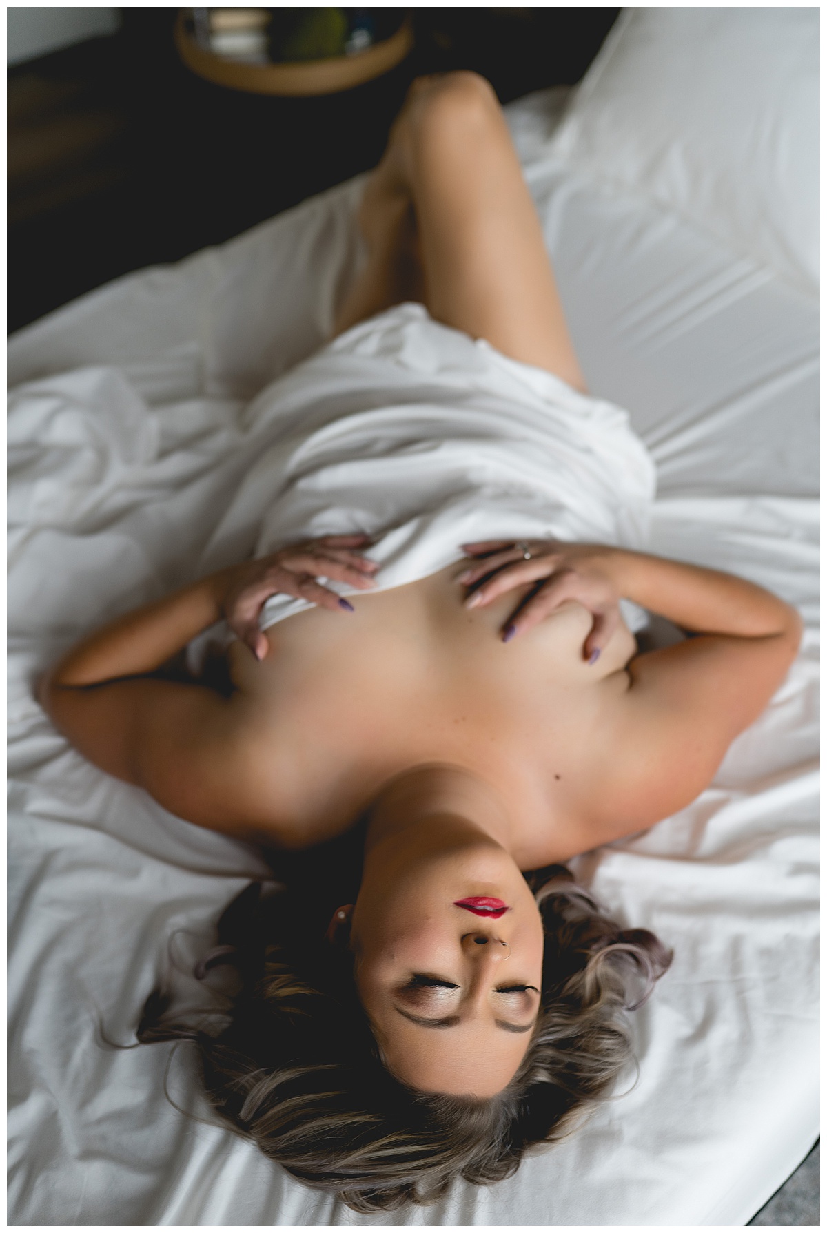 Woman grabs her body with a white sheet for Emma Christine Photography