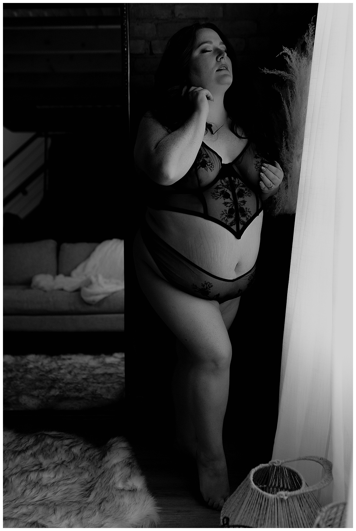 Female stands tall in black lingerie for Sioux Falls Boudoir Photographer