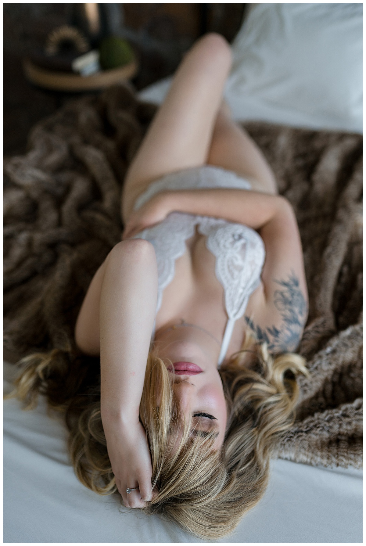 Lady lays on bed for Emma Christine Photography