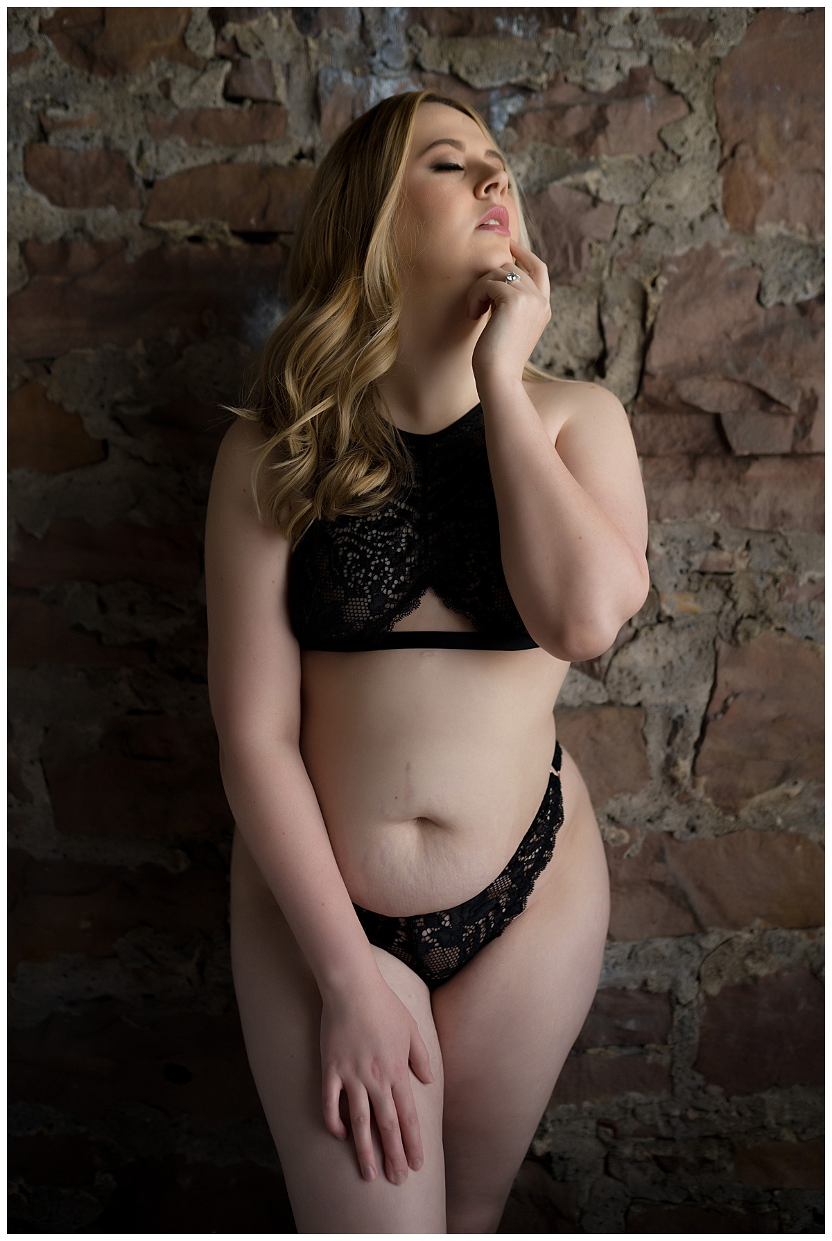 Blonde standing against wall for Emma Christine Photography