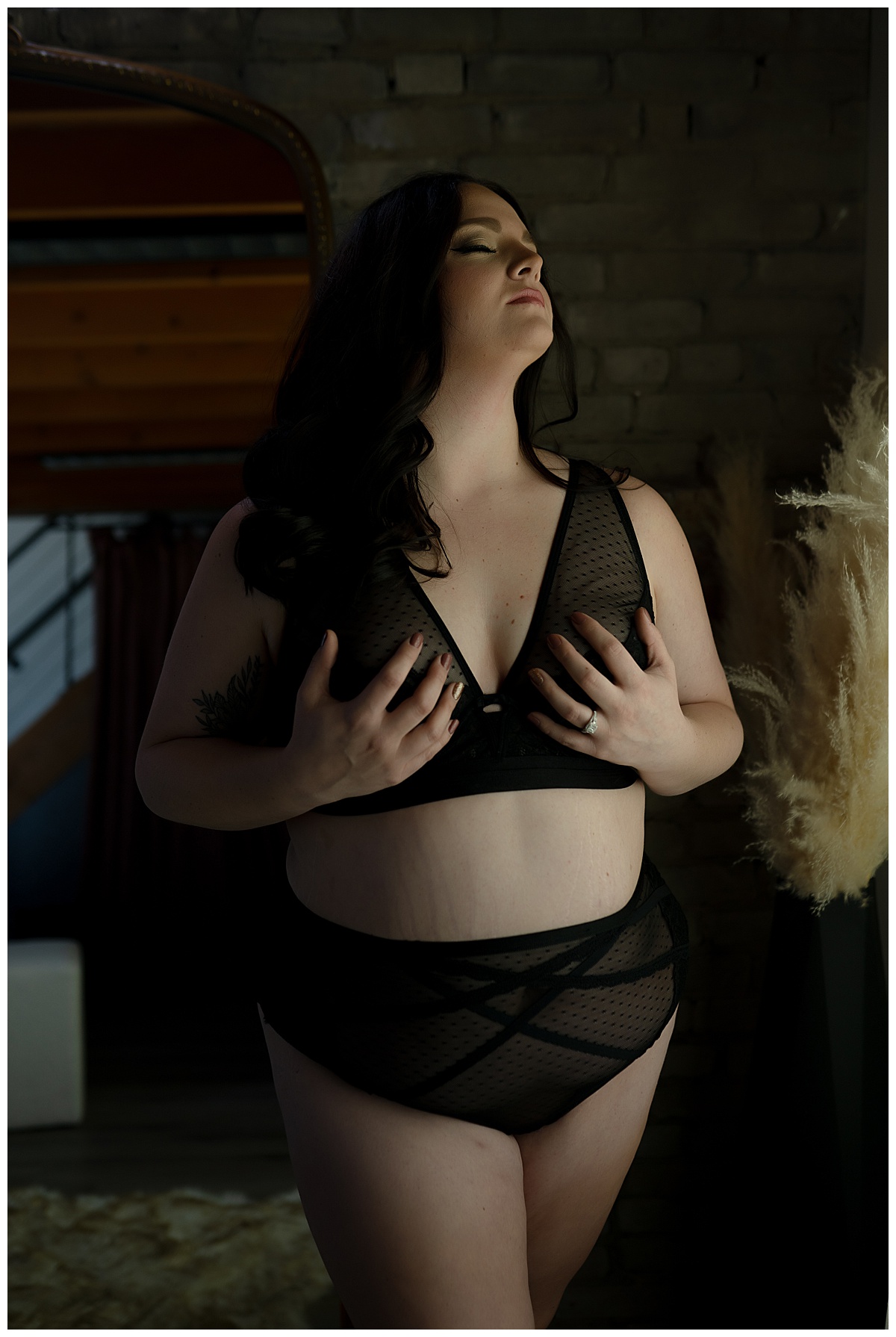 Adult grabs chest in black lingerie for Emma Christine Photography
