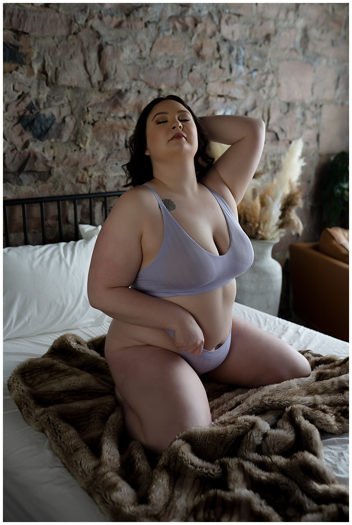 Client kneels on bed in lavender lingerie for Emma Christine Photography