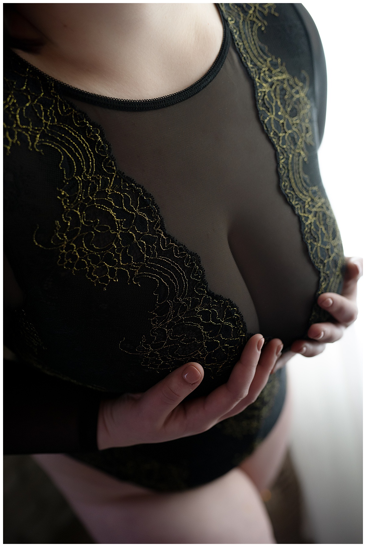 Adult suggests Book Your Boudoir Session as she covers chest with hands wearing black lingerie 
