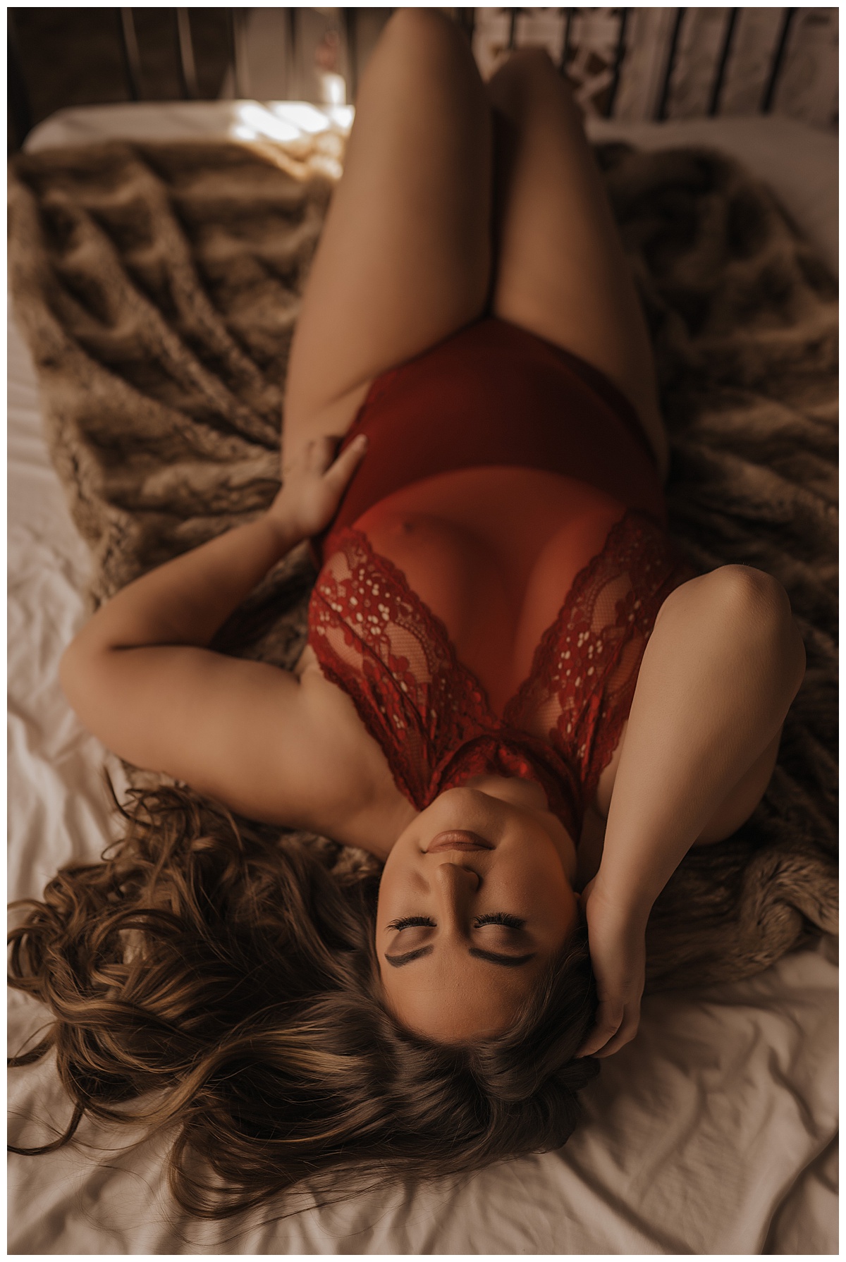 Woman lays down in red lingerie after finding Places to Buy Lingerie For Boudoir Session 