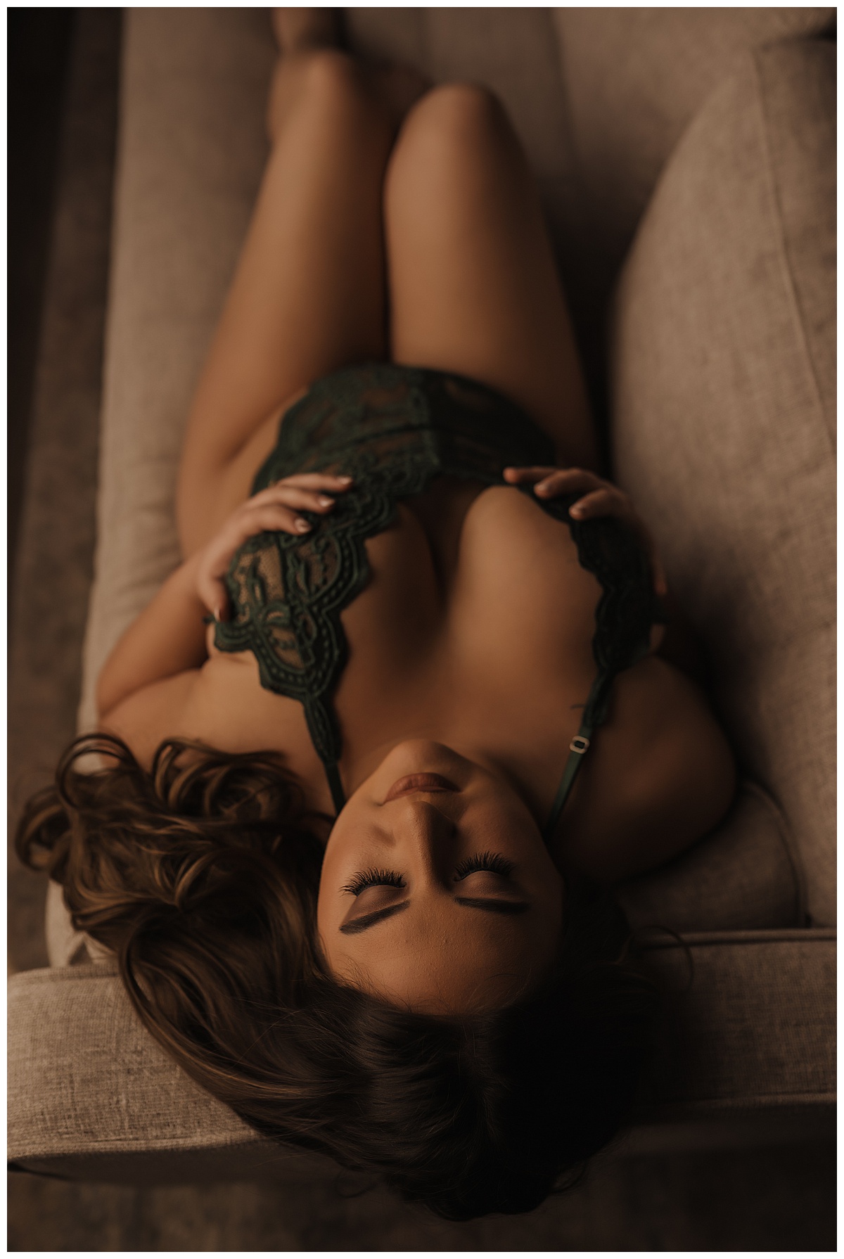 Lady holds chest sitting on couch for Emma Christine Photography