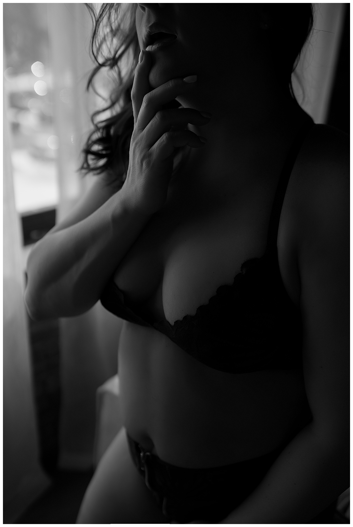 Lady holds finger to mouth for Sioux Falls Boudoir Photographer