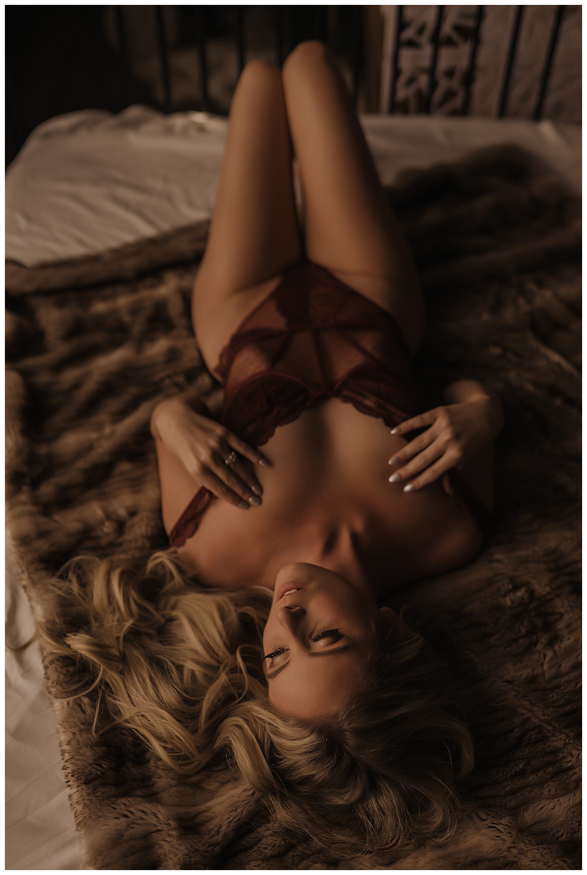 Girl wears red lingerie on bed before Using A Veil For Your Boudoir Session