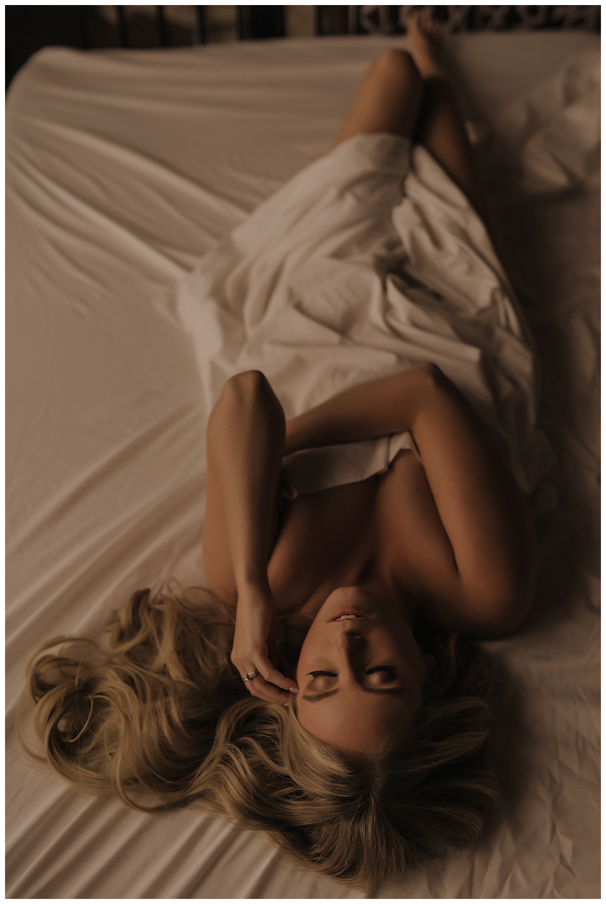 Female covers body with blanket for Emma Christine Photography