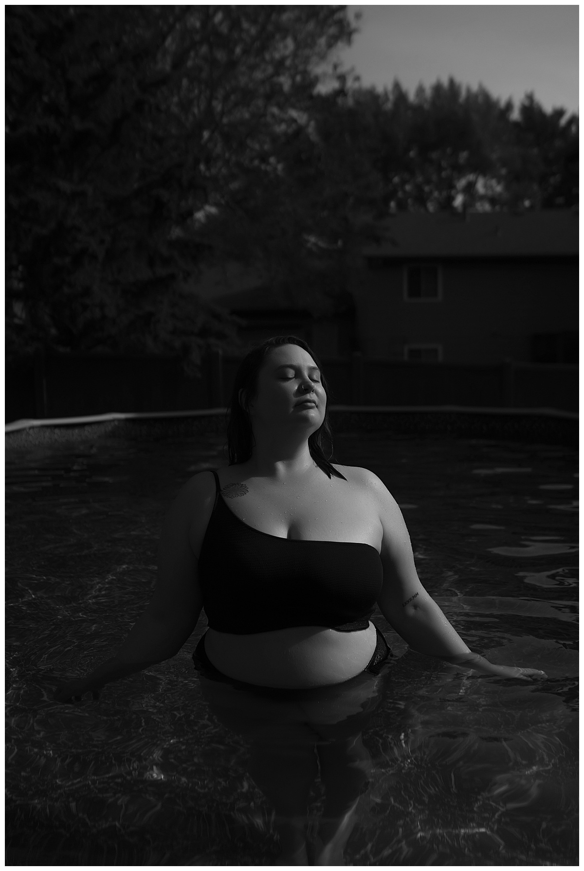 Woman wears a black bathing suit for Sioux Falls Boudoir Photographer