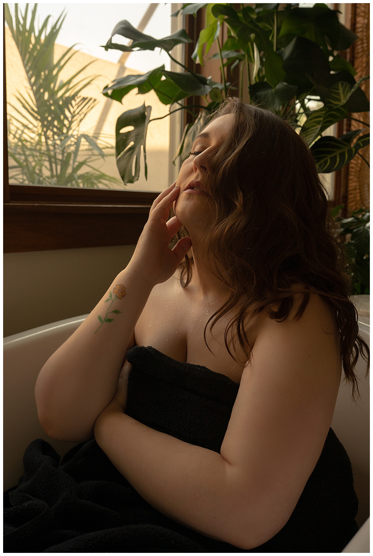 Adult sits in tub for Sioux Falls Boudoir Photographer