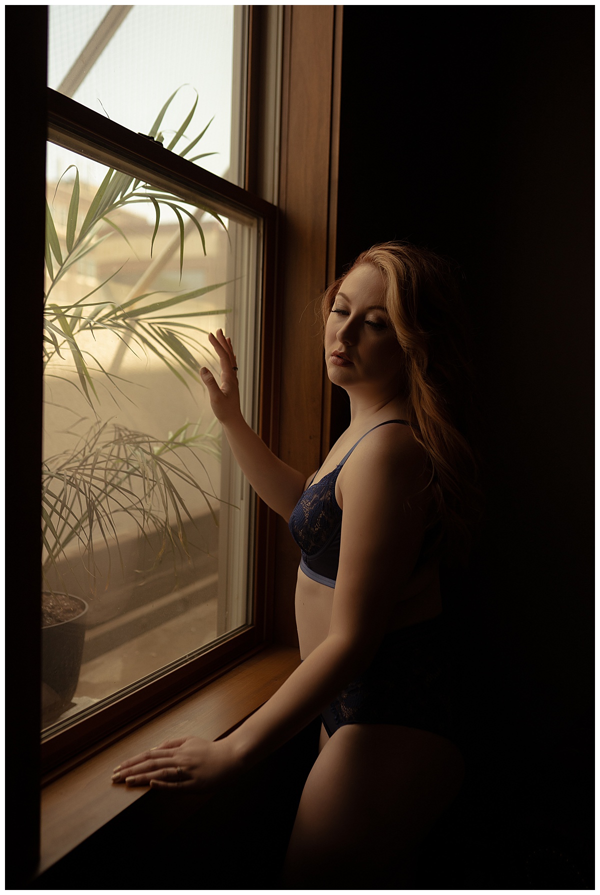 Girls leans in to the window for Sioux Falls Boudoir Photographer