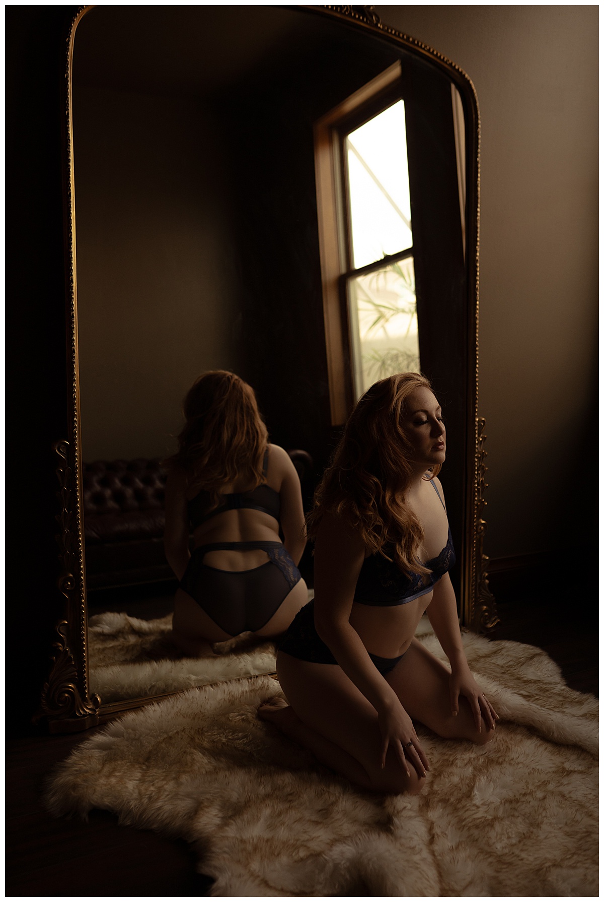 Girl kneels down in front of mirror for Sioux Falls Boudoir Photographer