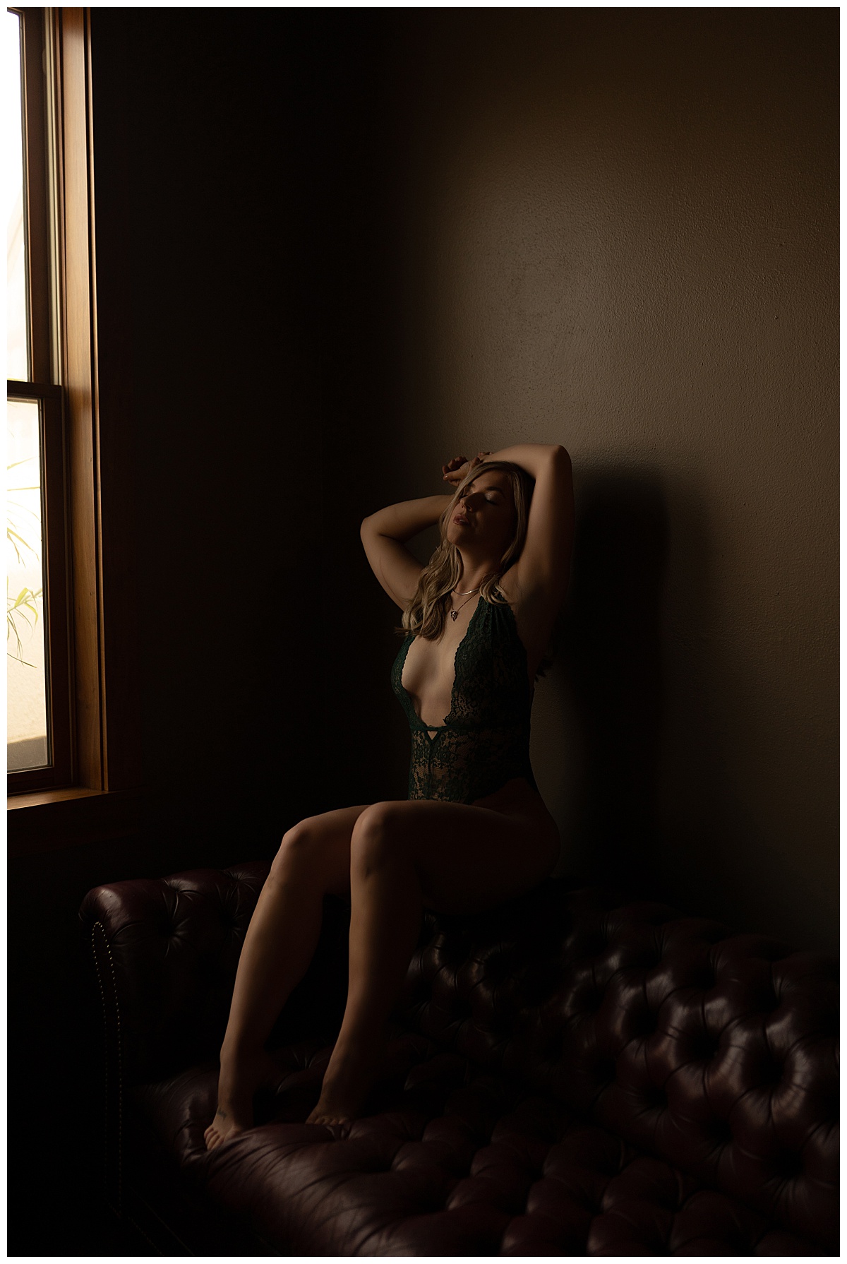 Lady sits on top of a couch for Sioux Falls Boudoir Photographer
