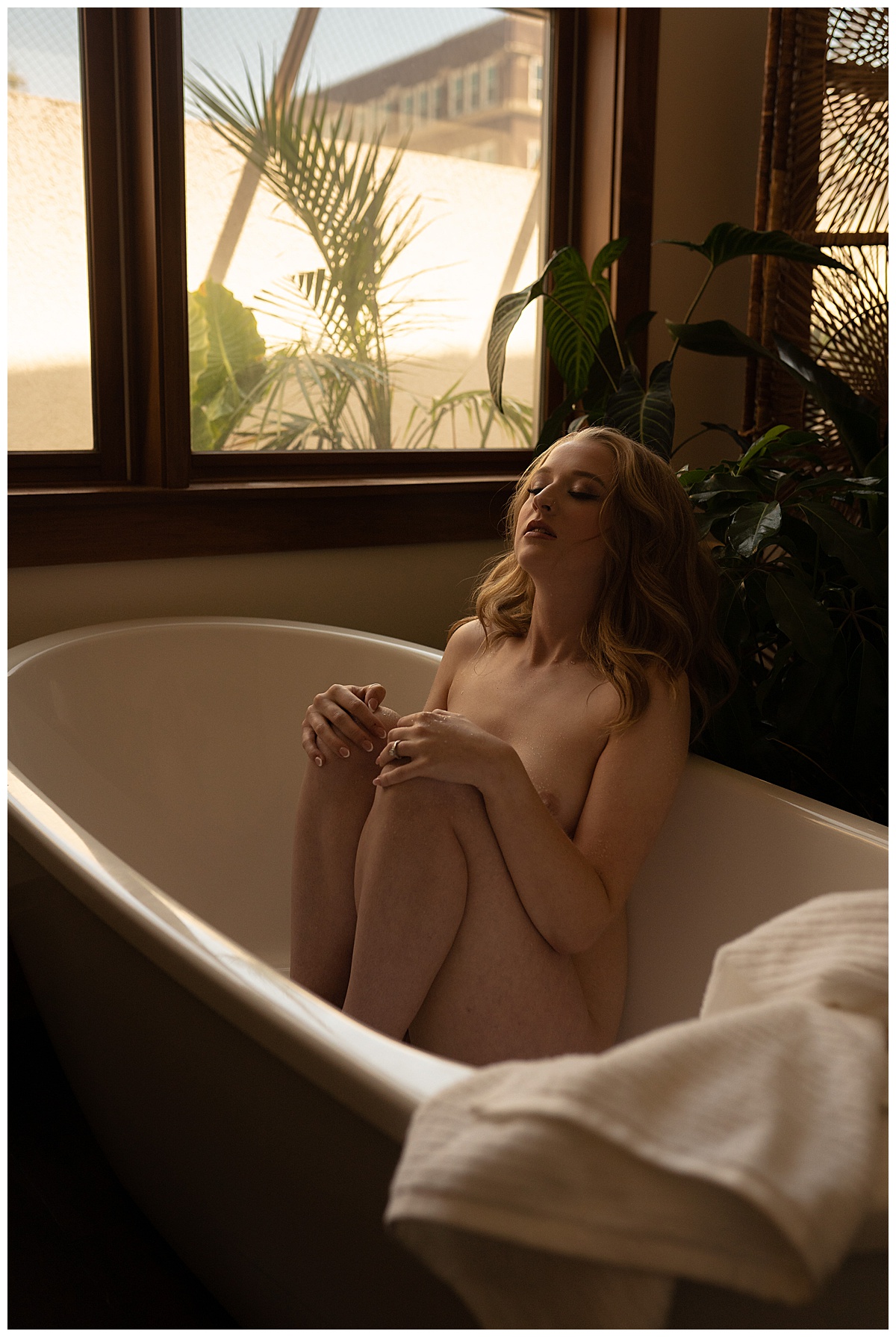 Girl sits in the tub for Sioux Falls Boudoir Photographer