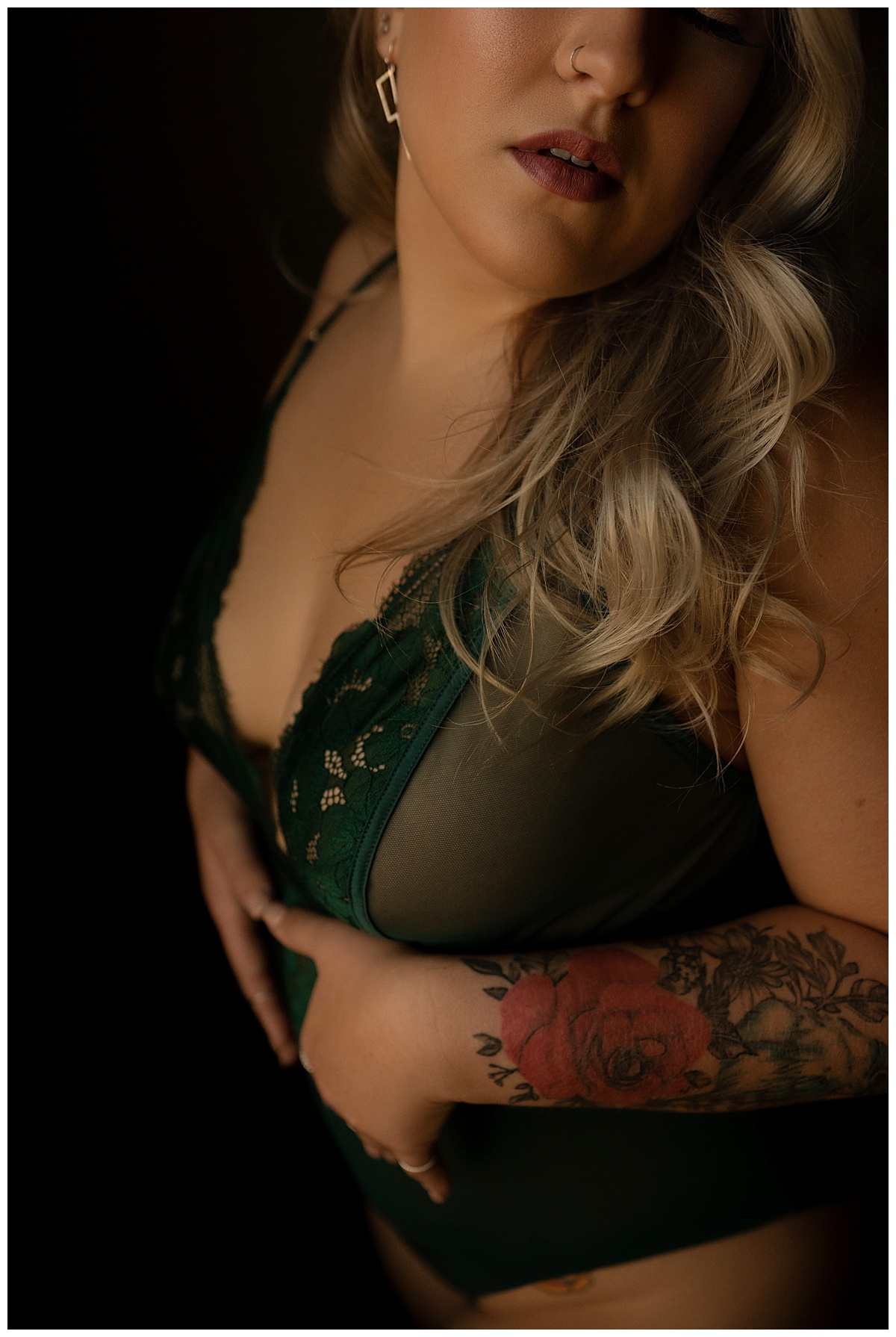 Lady covers body with hands wearing green lingerie for Emma Christine Photography
