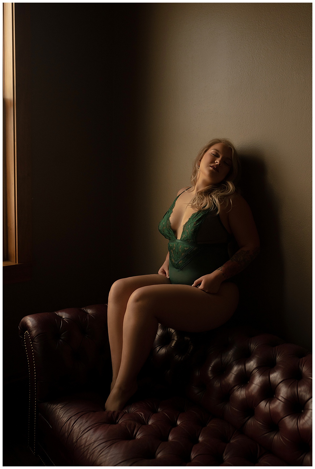Female sits on the couch wearing green lingerie after following tips to do  Before Your Boudoir Session