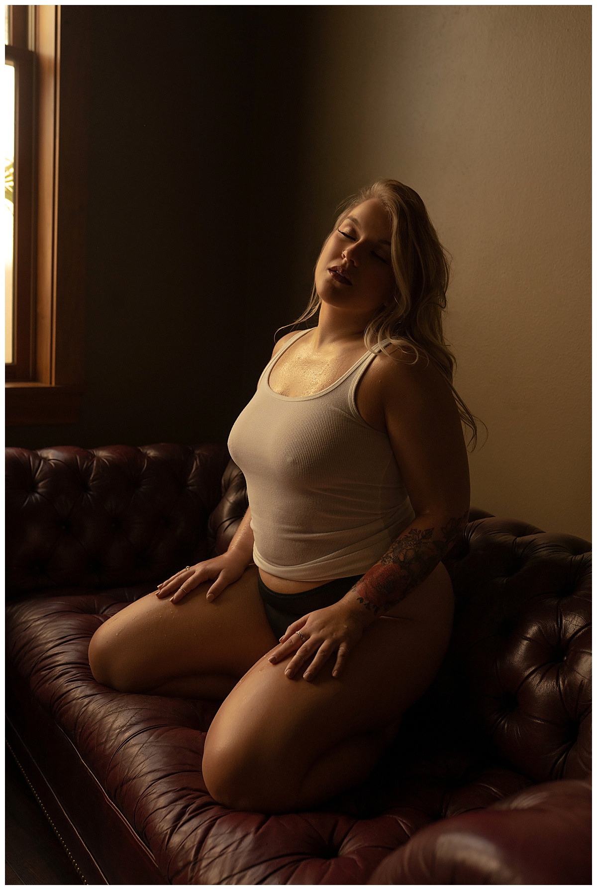 Female kneels down wearing a white t-shirt after following tips to do Before Your Boudoir Session