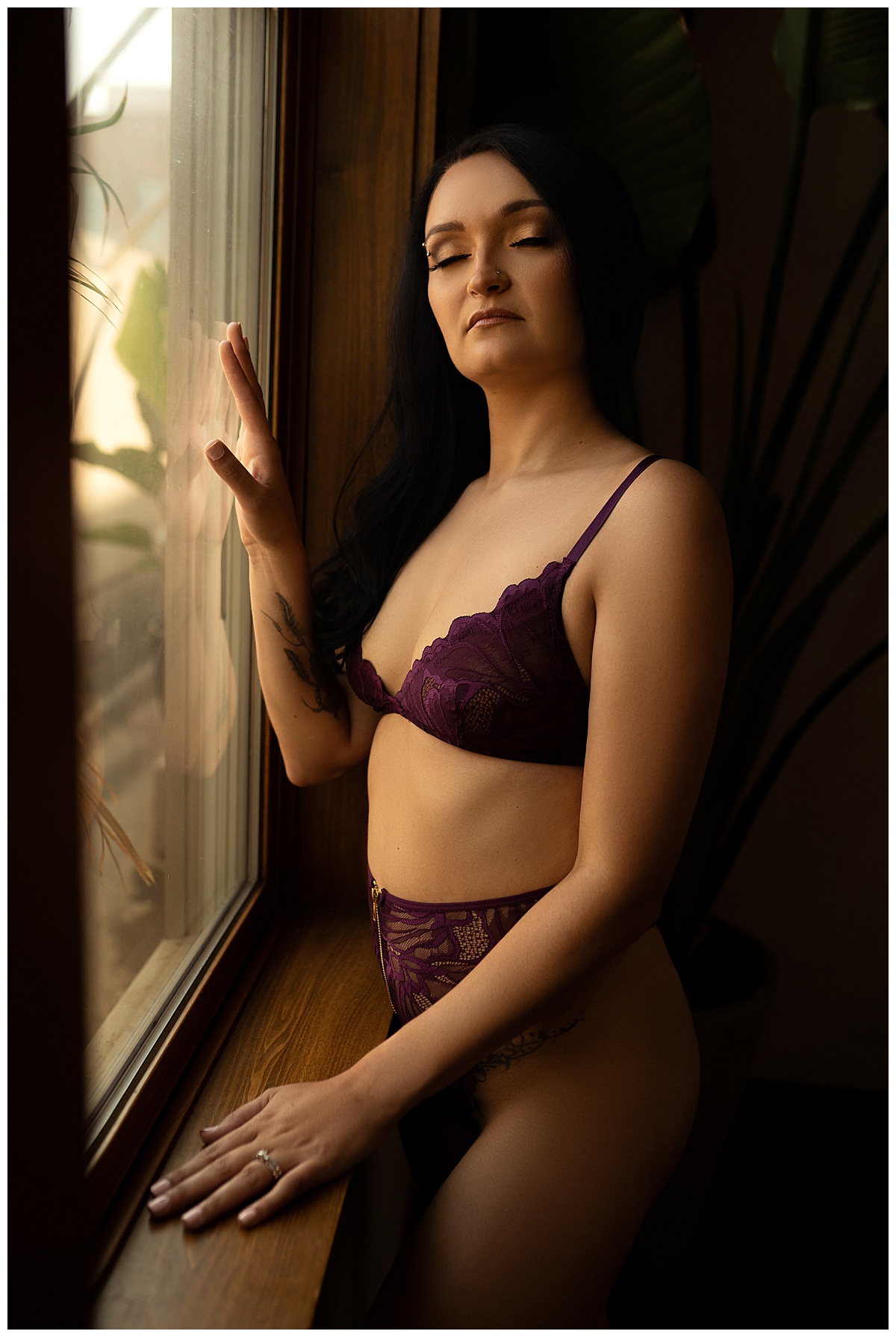 Female stands in front of window for  Emma Christine Photography