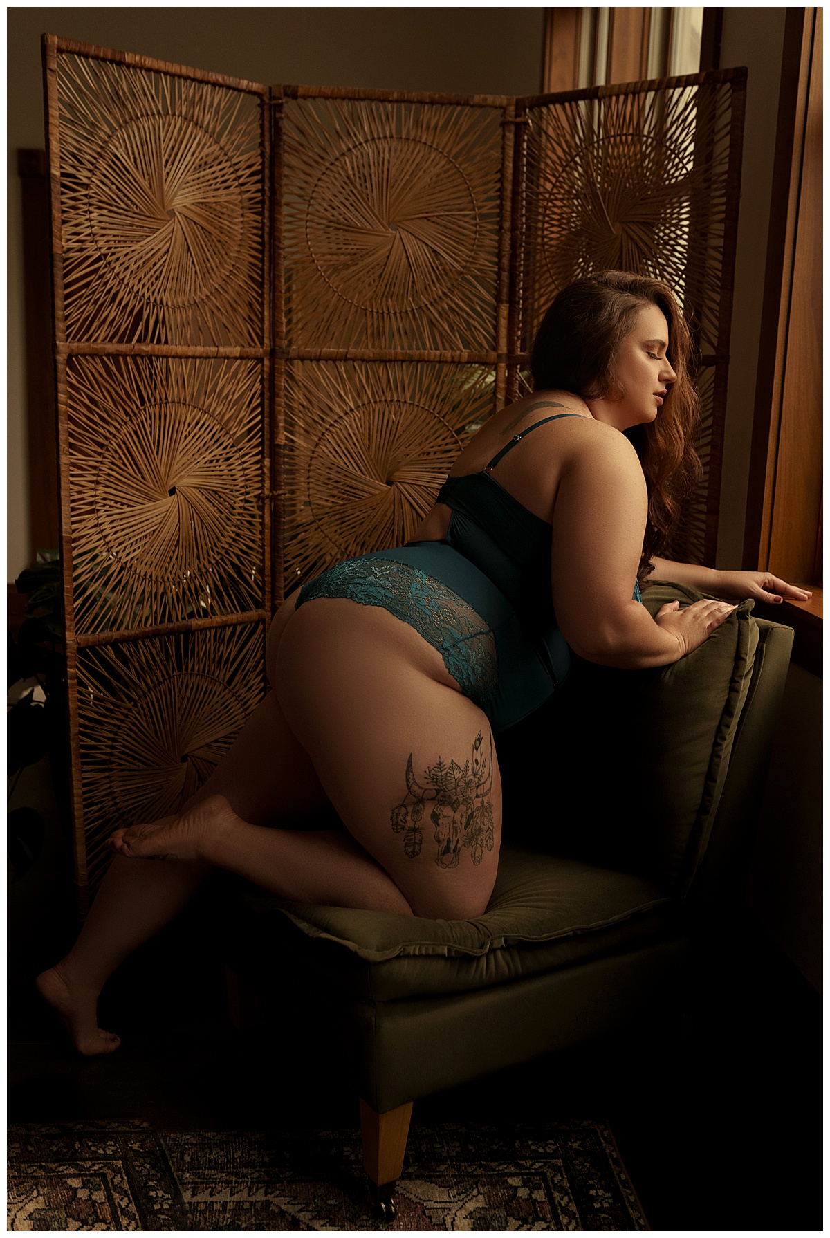 Female leans on a couch for Emma Christine Photography