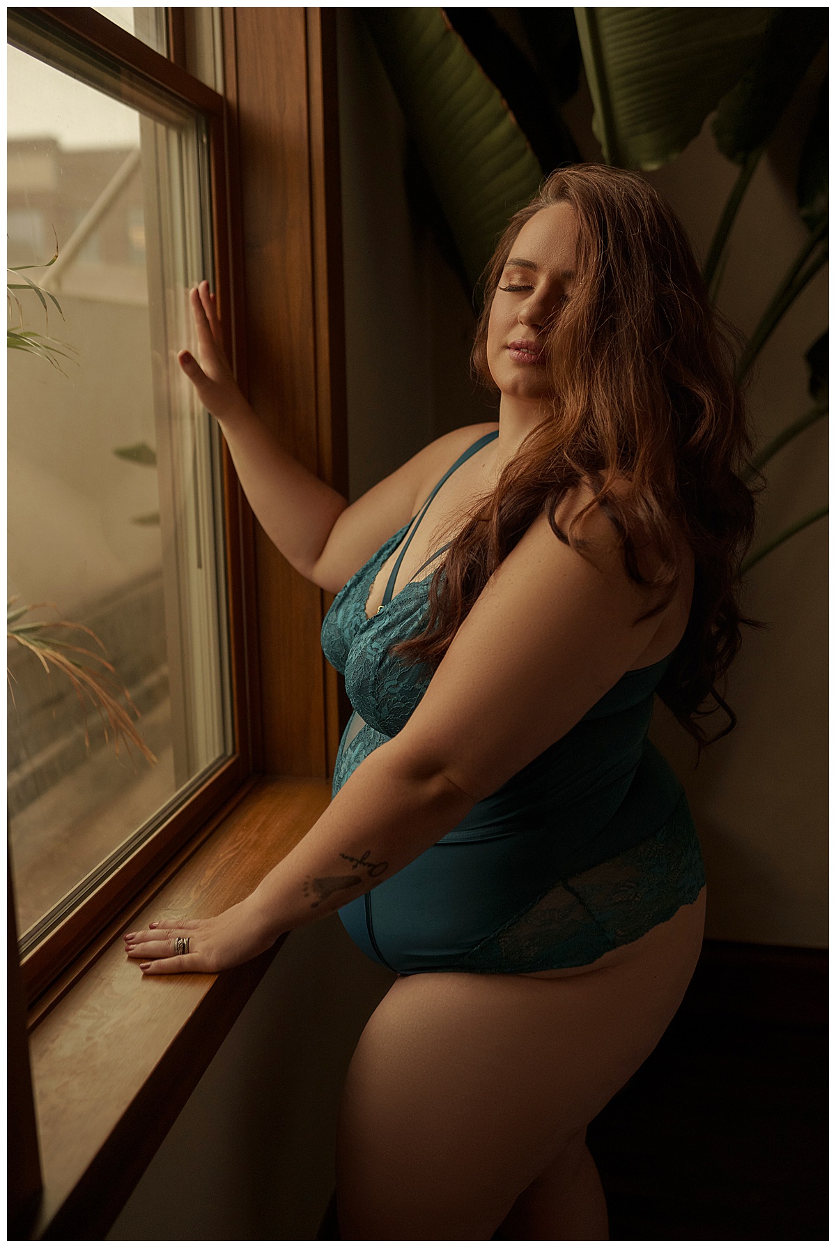 Woman steps out of her Comfort Zone and stands in front of a window wearing lingerie