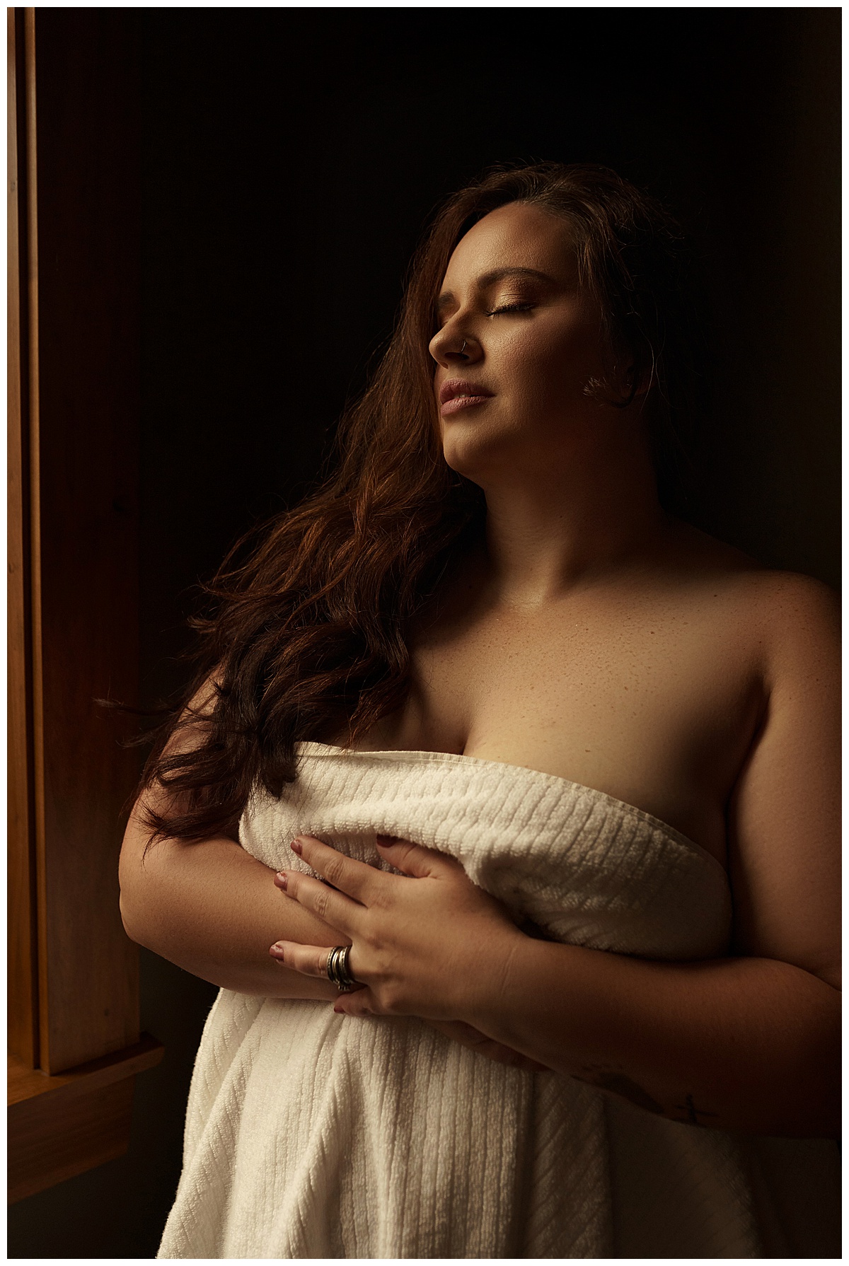 Female covers her body with a towel for Emma Christine Photography