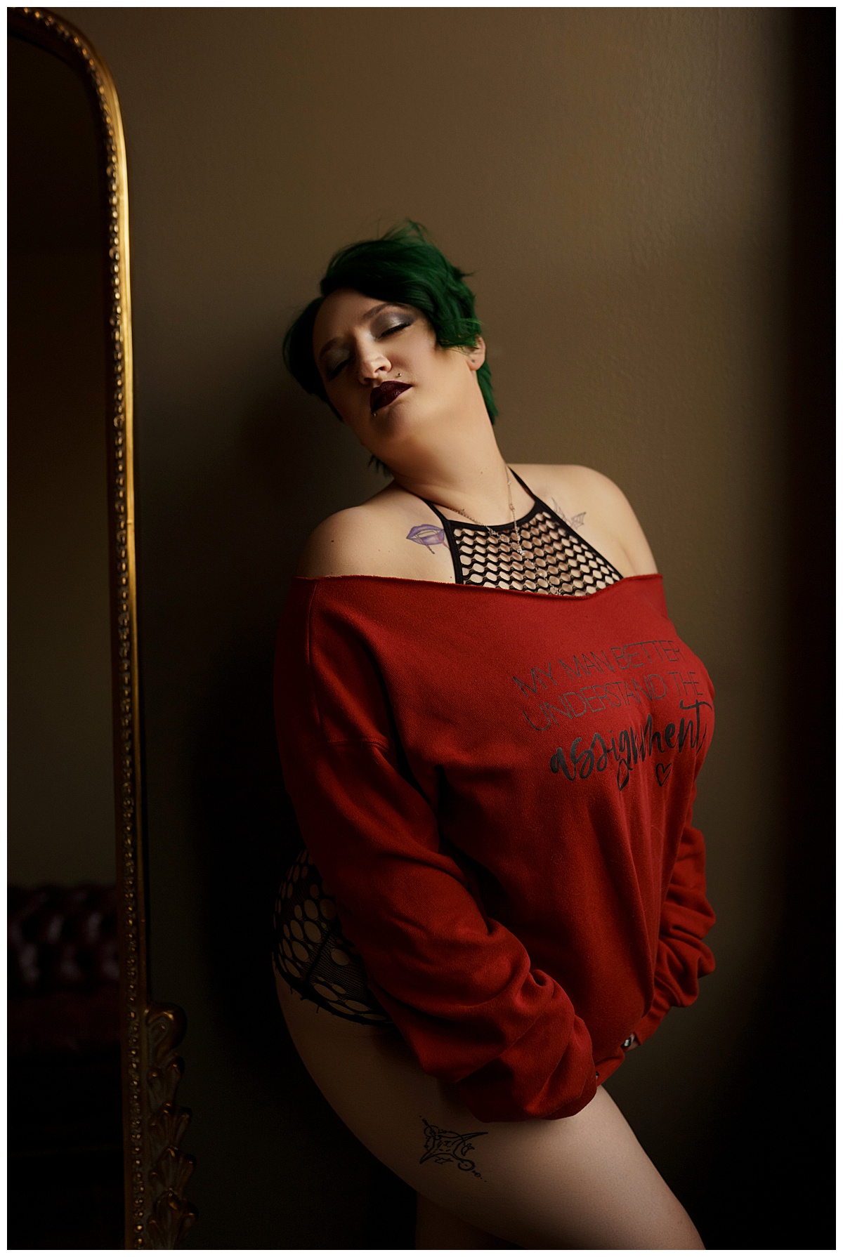 Woman wears bright red sweater for  Sioux Falls Boudoir Photographer