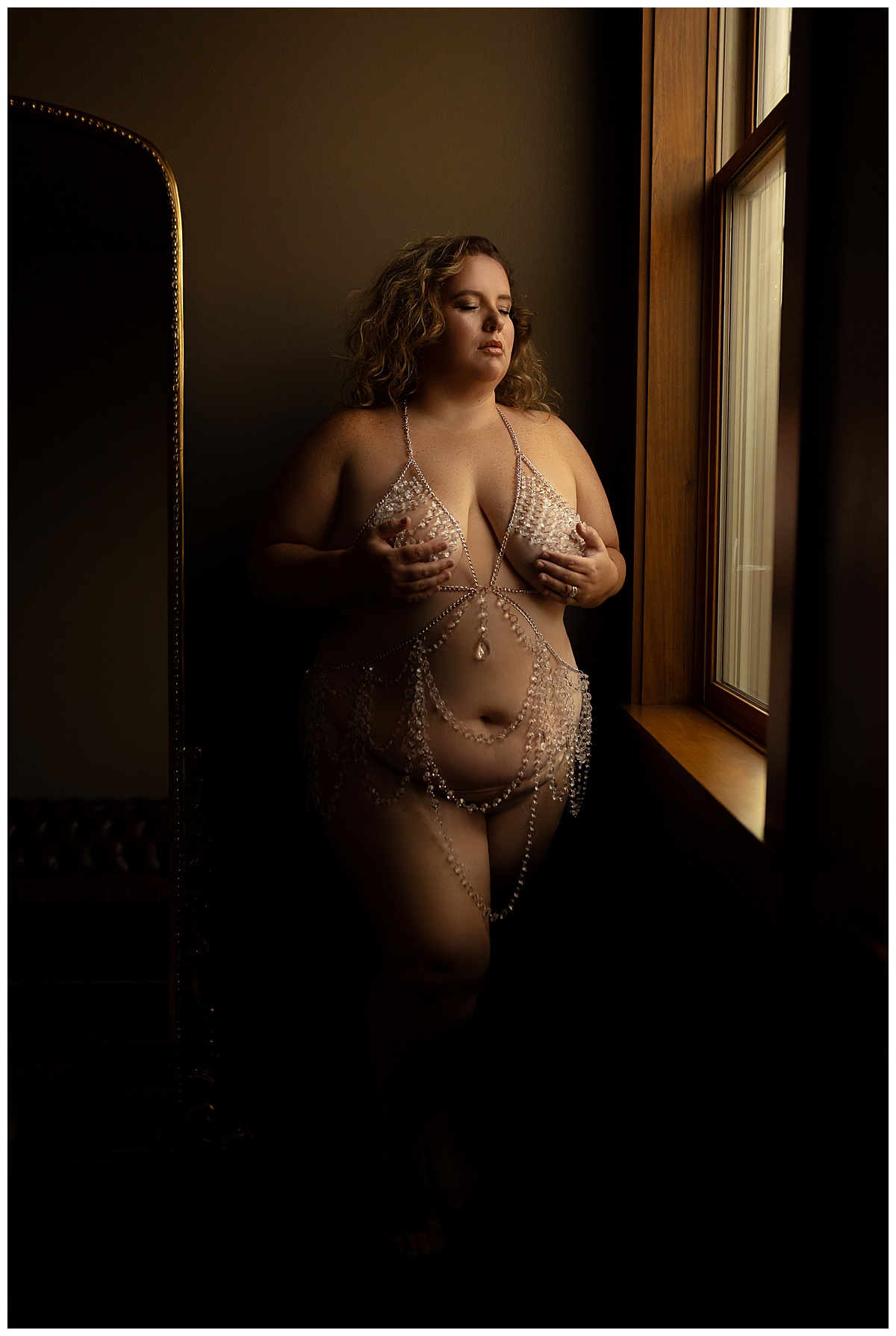 Adult covers her chest with her hands for Sioux Falls Boudoir Photographer