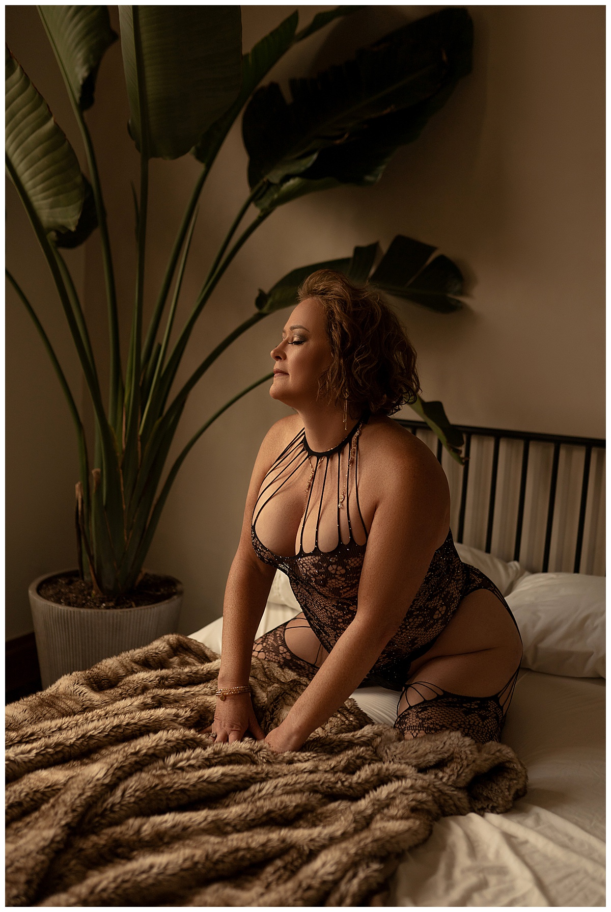 Adult kneels forward onto bed wearing lingerie for Emma Christine Photography