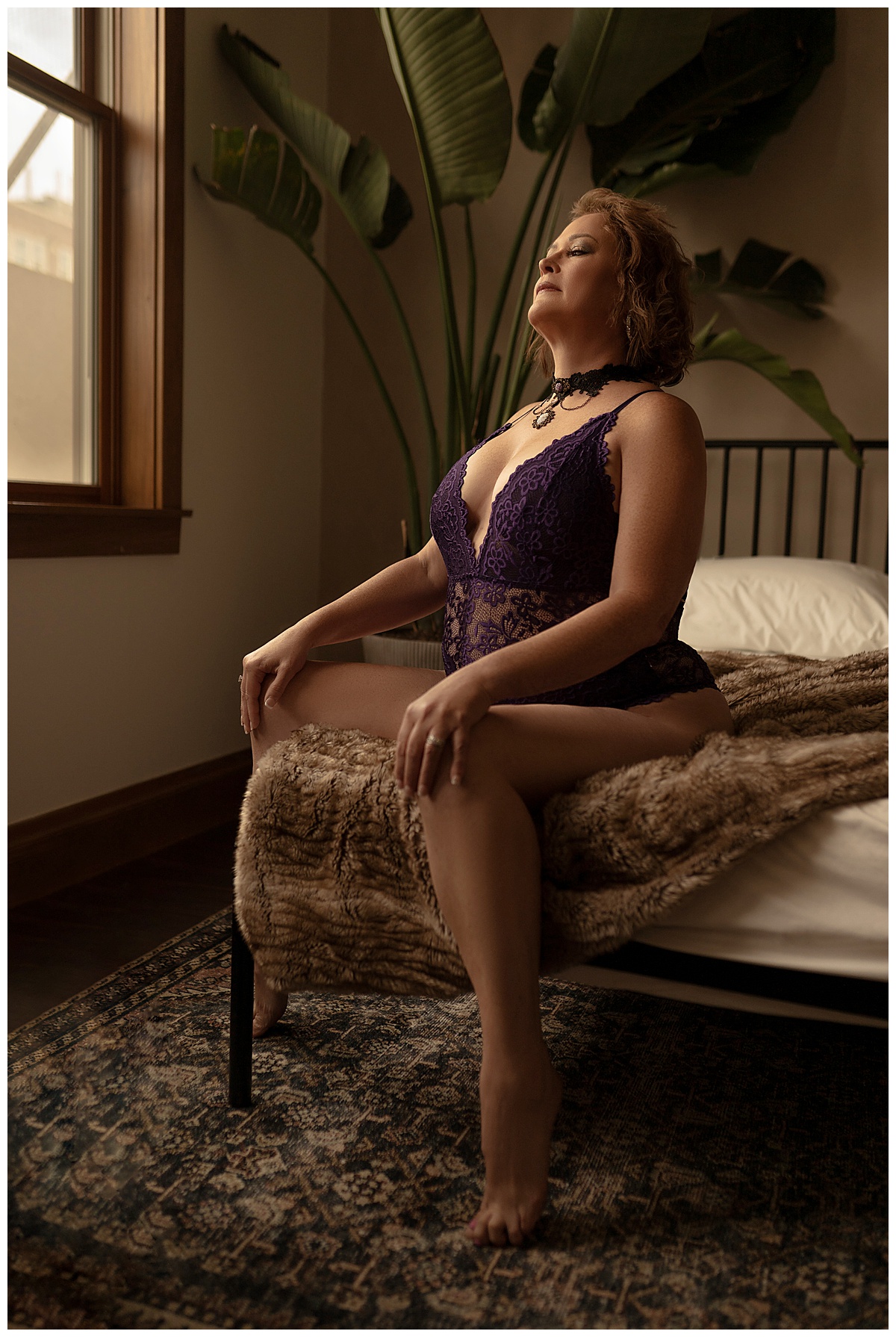 Woman sits on the edge of the bed for Sioux Falls Boudoir Photographer
