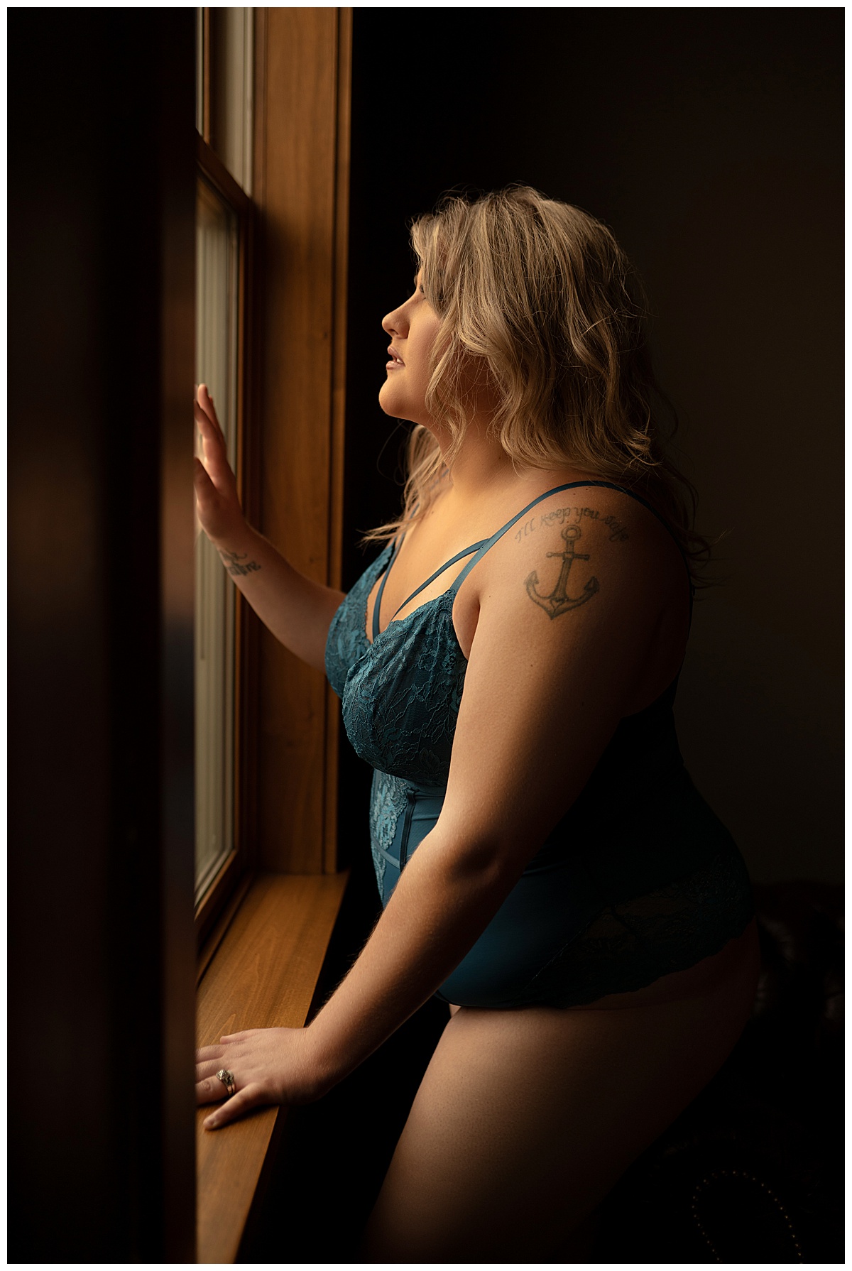 The adult stands in front of a mirror wearing Blue Lace Lingerie 