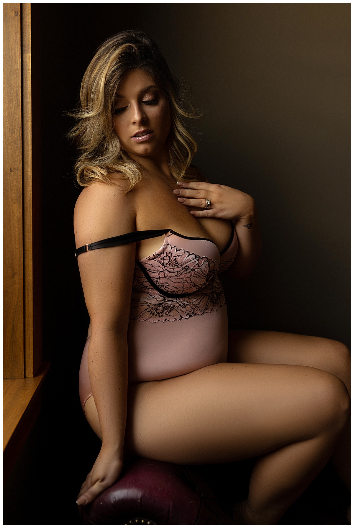 Person sits on the chair wearing lingerie for Sioux Falls Boudoir Photographer