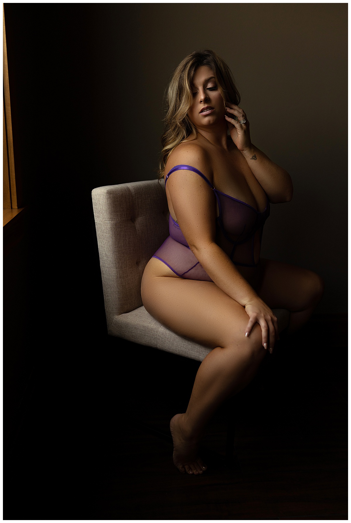 female sits on a chair for Emma Christine Photography