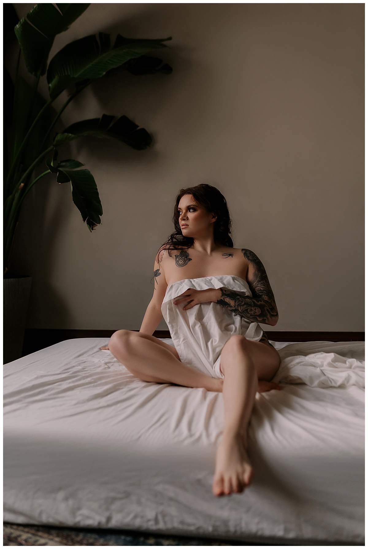 Female covers her body with a white sheet for Sioux Falls Boudoir Photographer