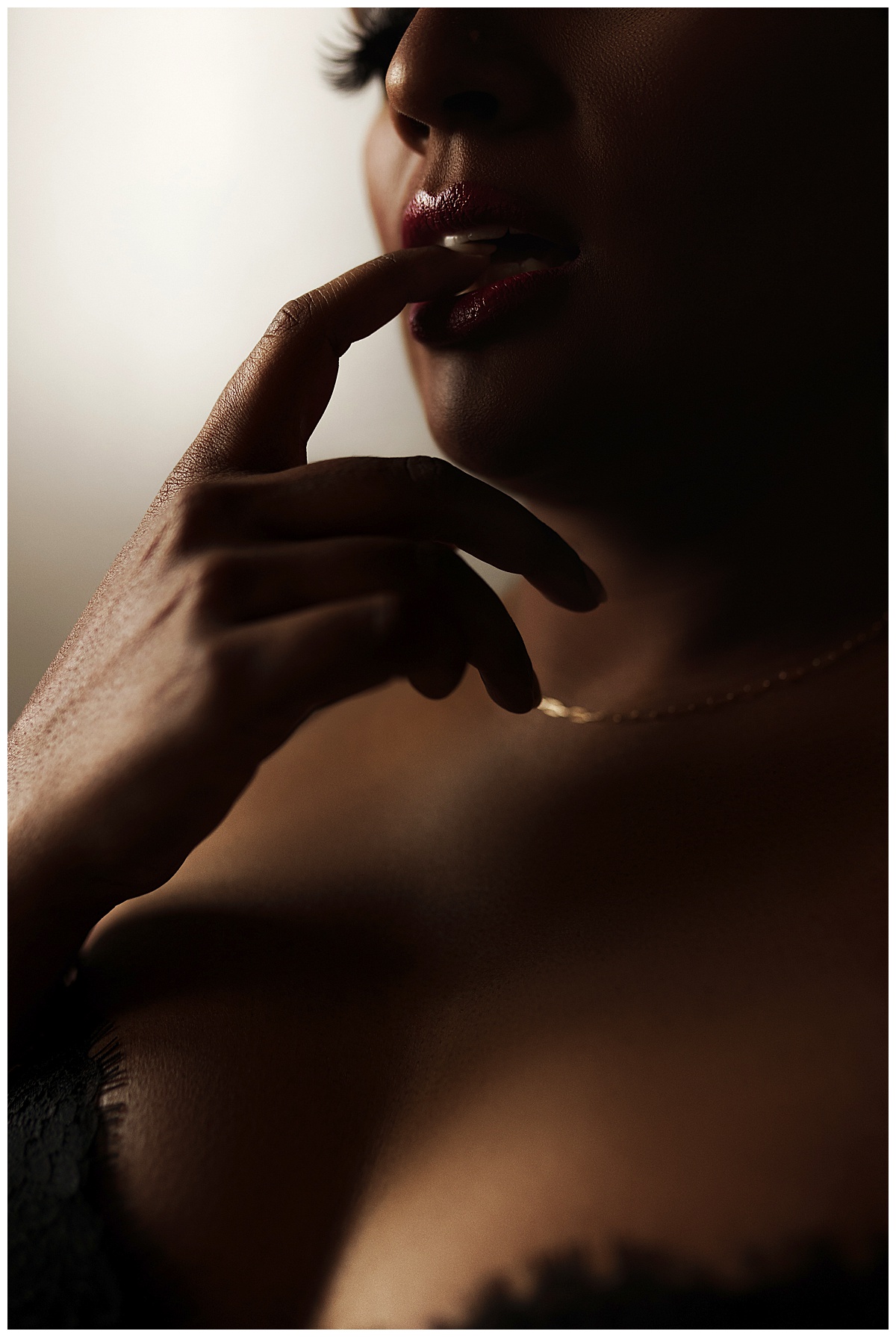 Person puts her finger tho her lips for the Best Boudoir Photographer