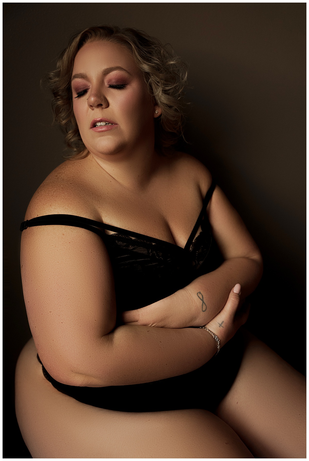 Person covers her chest with her arms wearing inclusive lingerie from Torrid