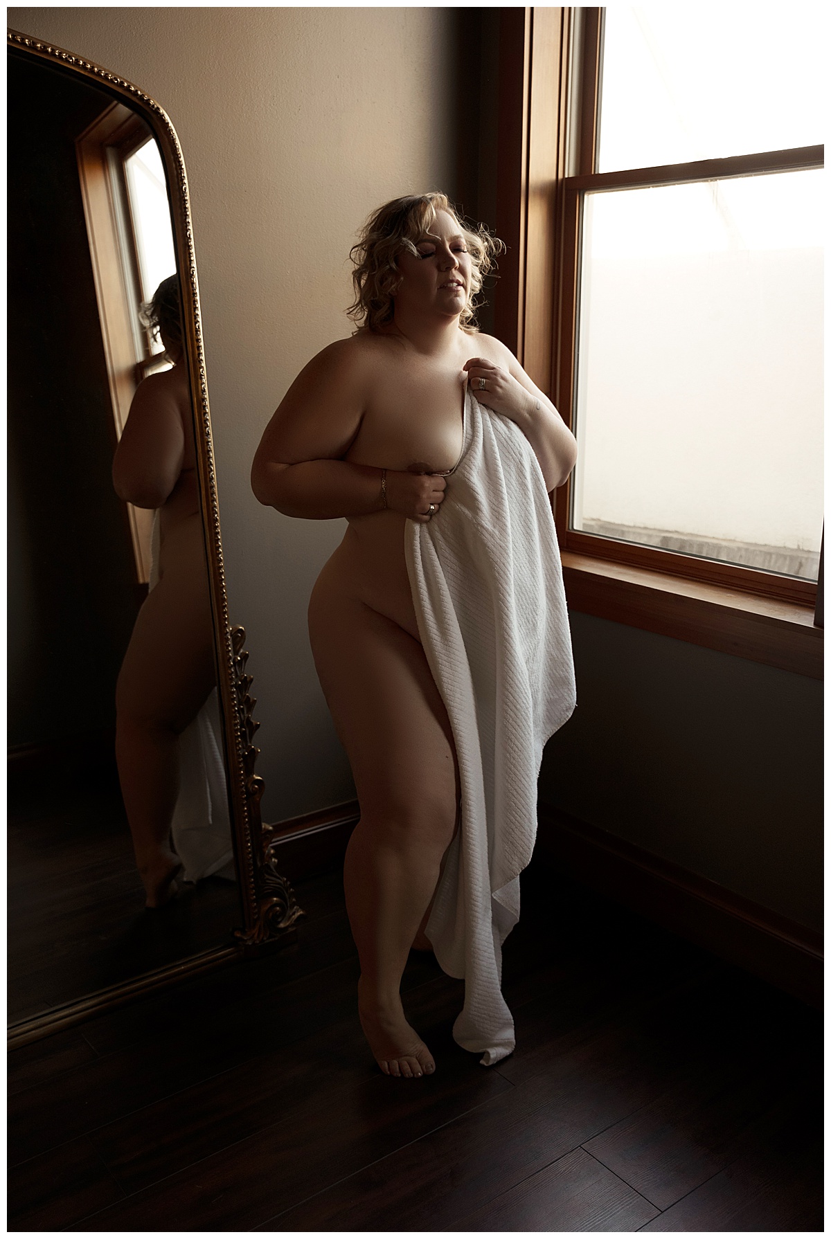 Female covers her body with a white sheet for Sioux Falls Boudoir Photographer