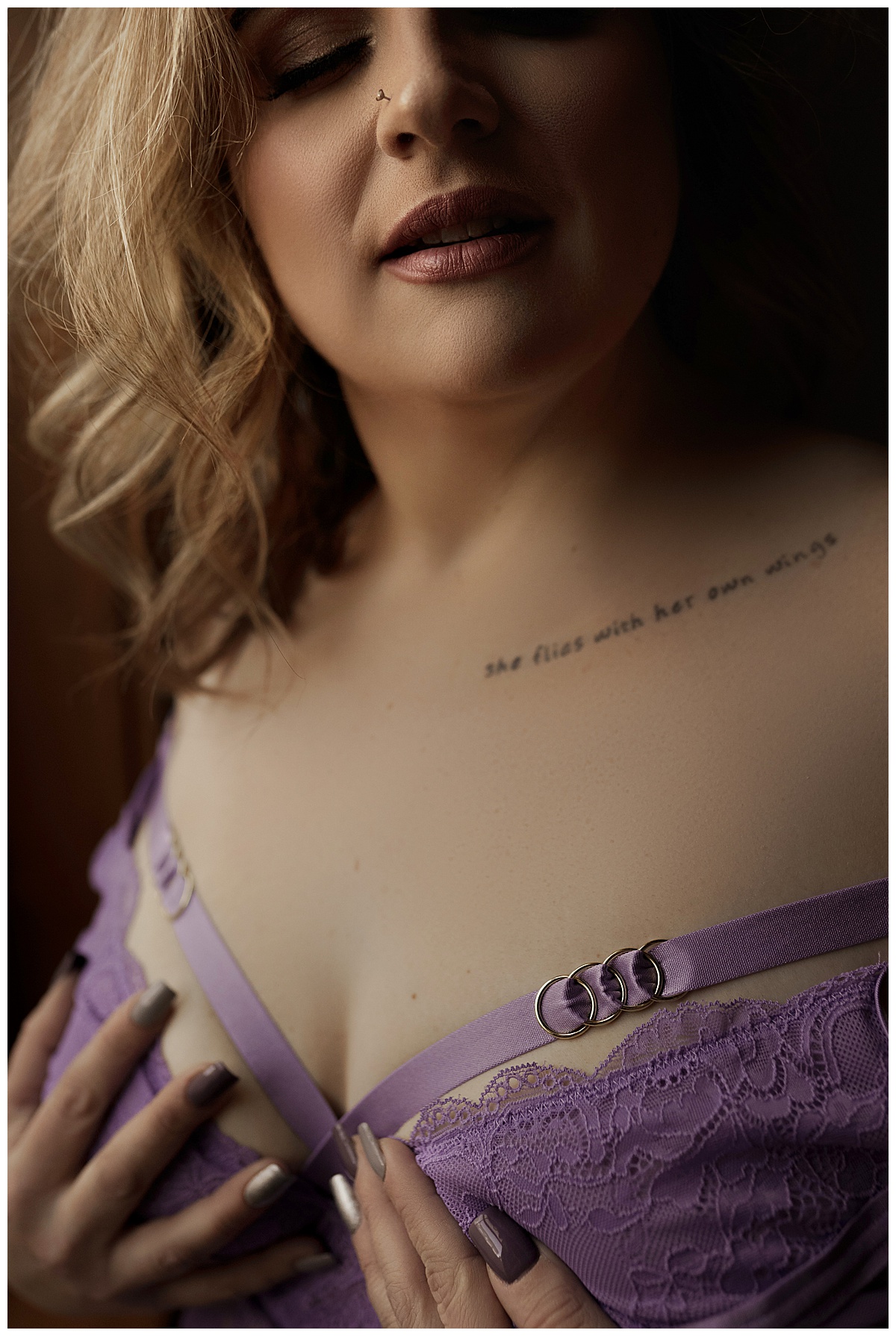 Female covers her chest wearing purple lingerie showing off her true beauty