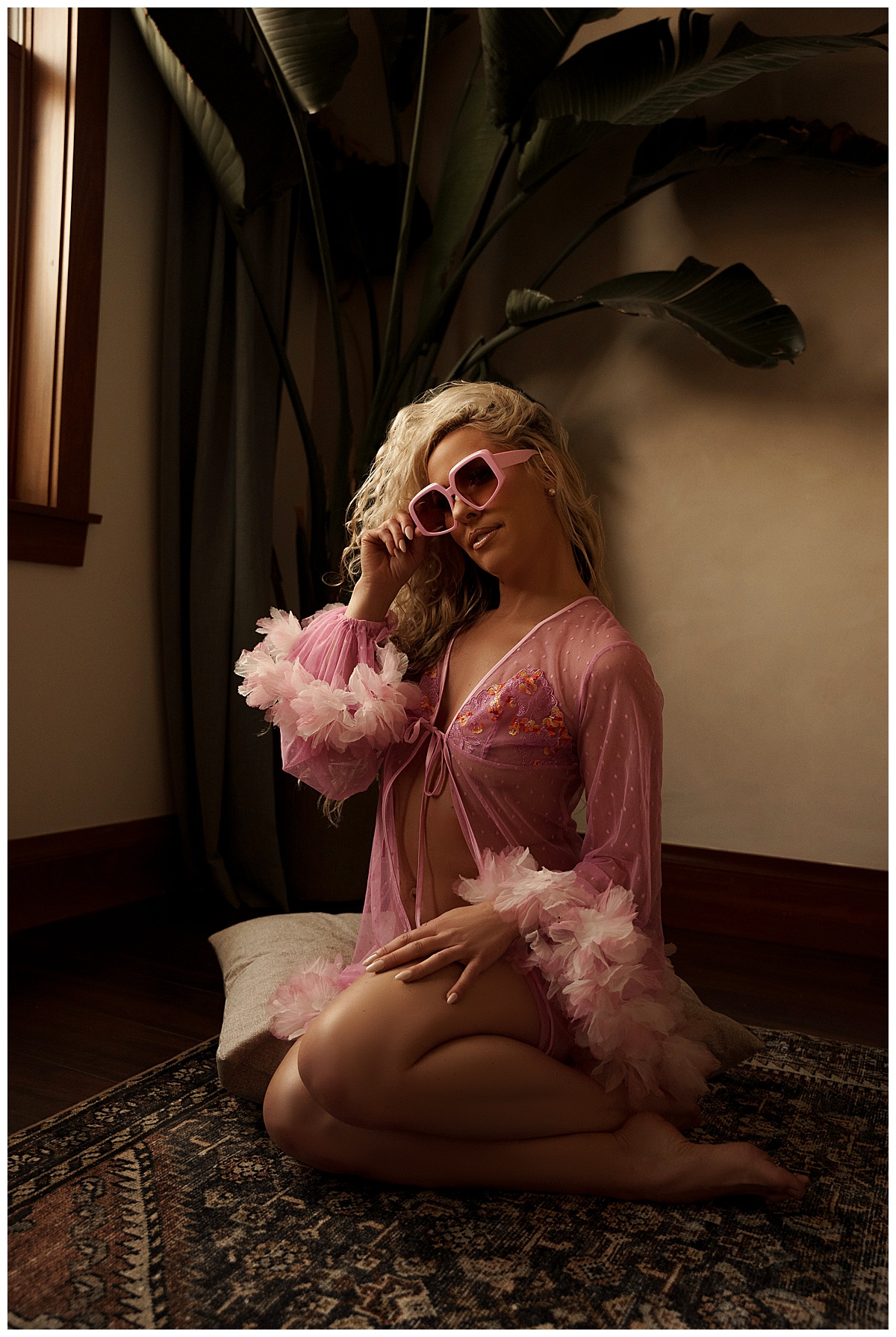 Woman tugs at pink sunglasses for Emma Christine Photography