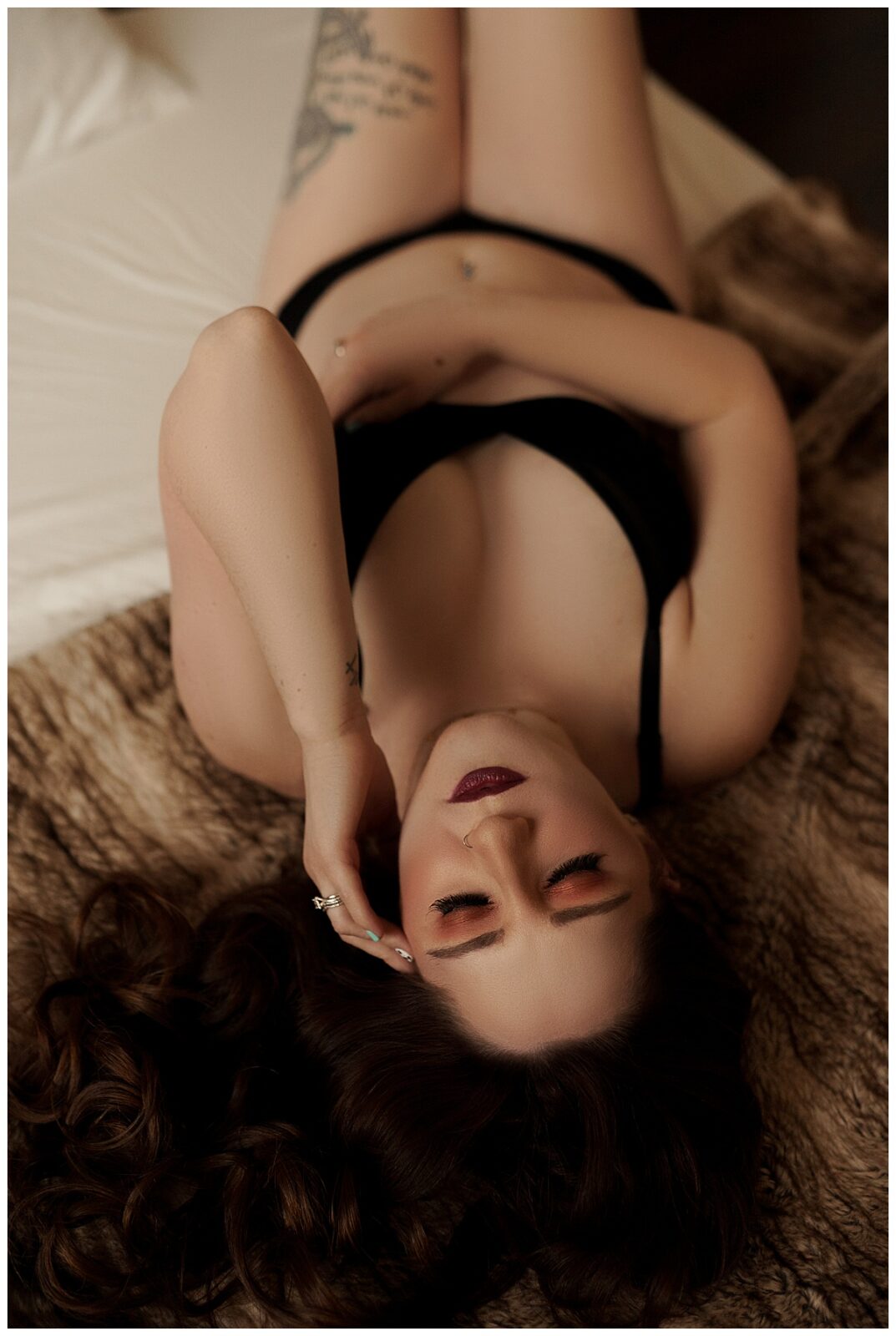 Woman lays on the floor with her hand to her head before using Small Props For Your Boudoir Experience