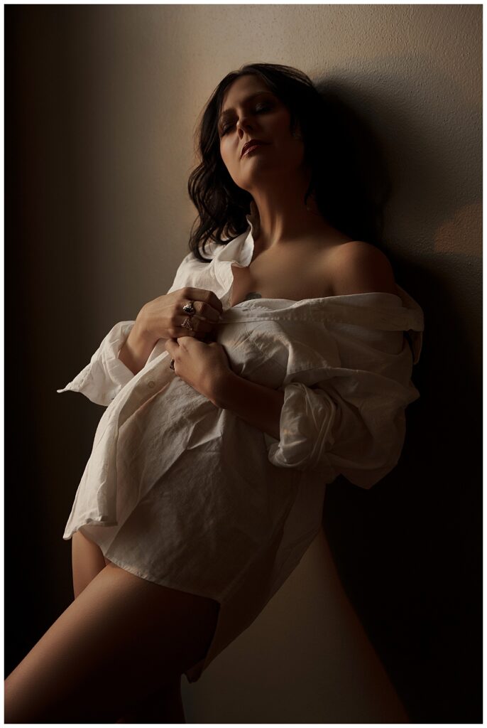 Adult covers body with white button-down for Sioux Falls Boudoir Photographer