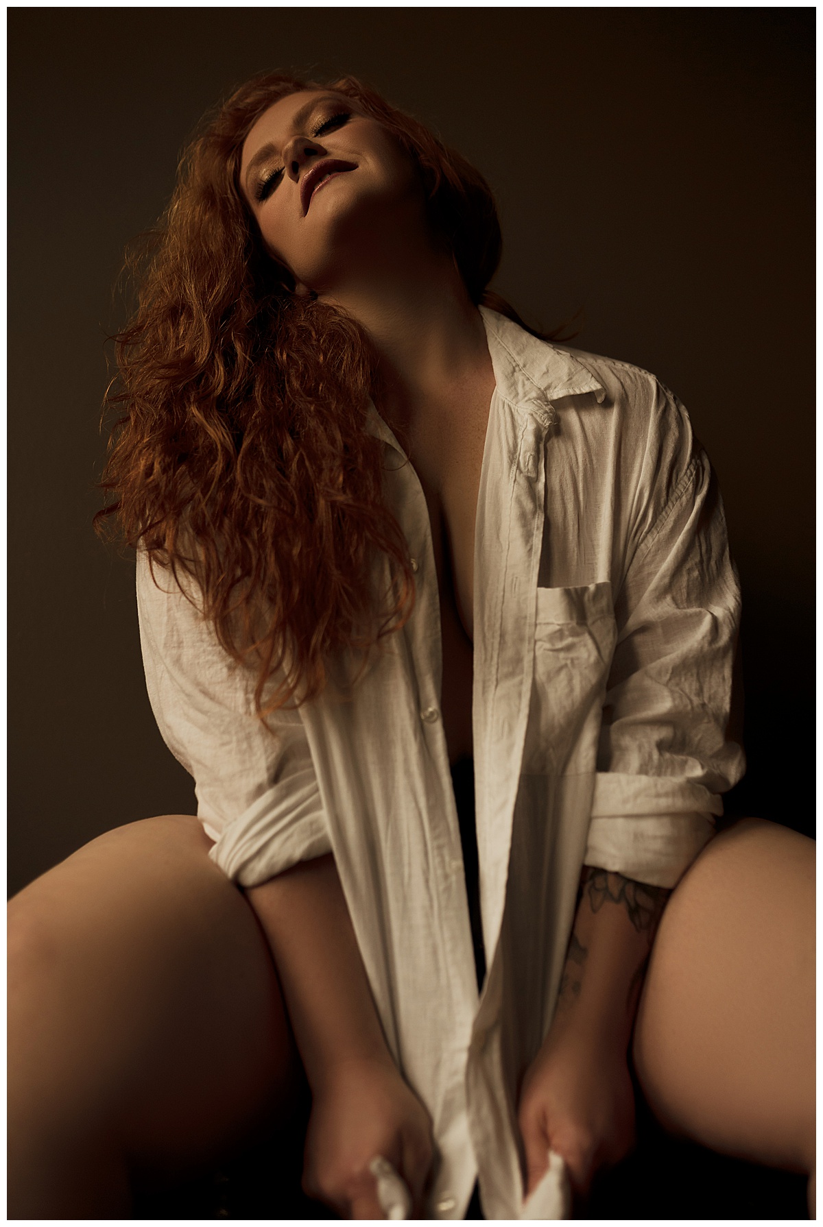 Woman sits down wearing a white cover up for Emma Christine Photography