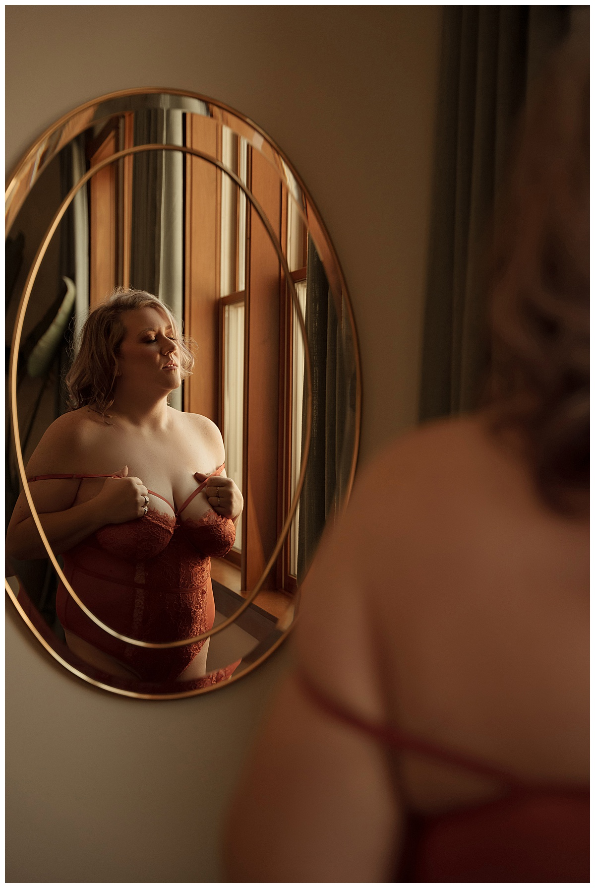 Woman stands in front of a mirror for Sioux Falls Boudoir Photographer