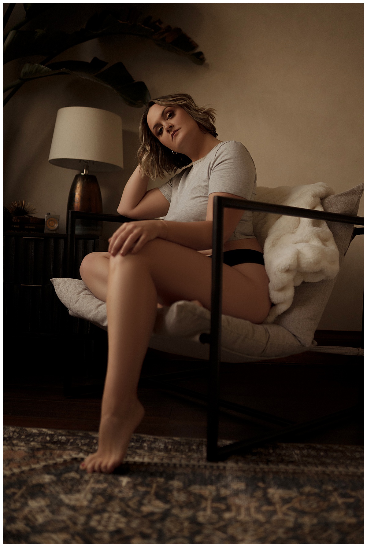 Person sits in the chair wearing lingerie showing how you can go From Insecurity to Empowerment during her boudoir session