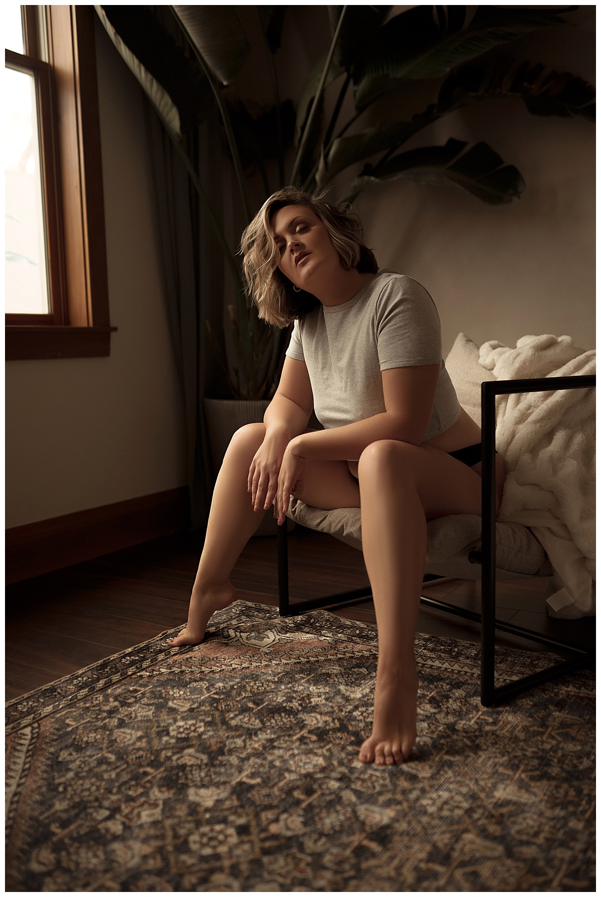 Person sits on a chair for Sioux Falls Boudoir Photographer